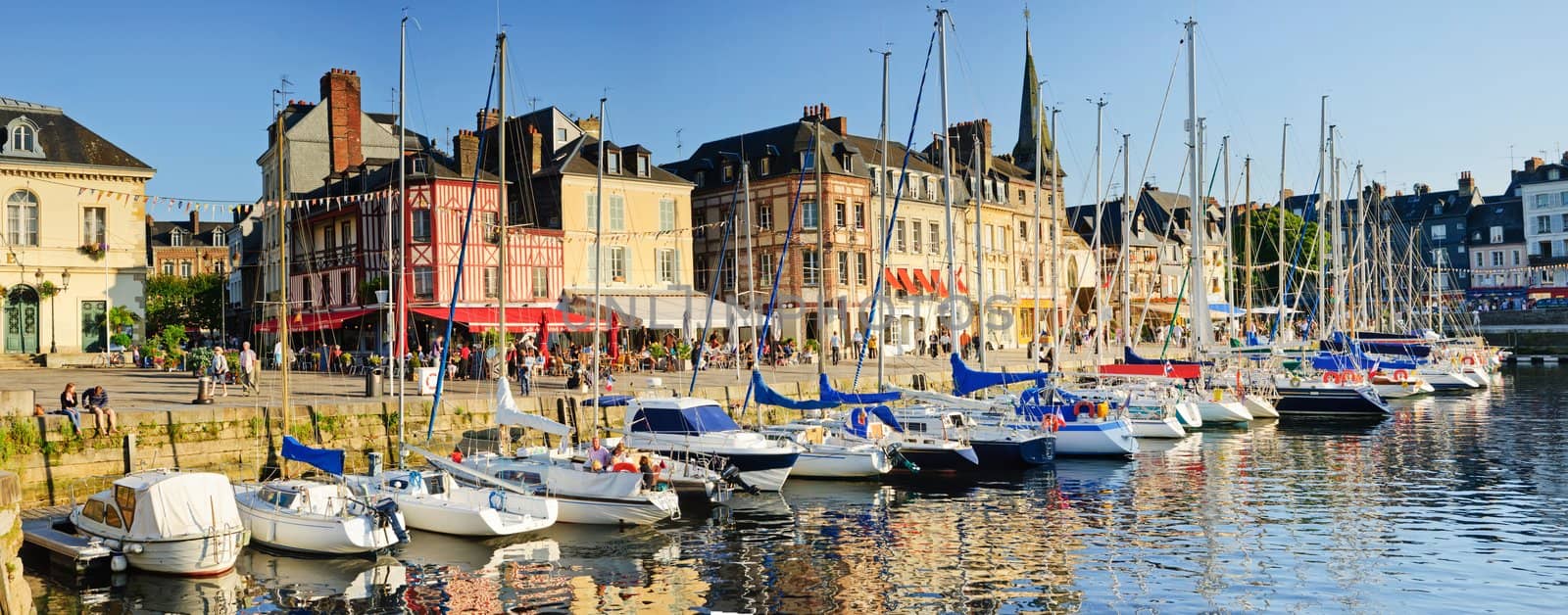Panorama. Sunset in Honfleur. View of the old harbor - boats, houses