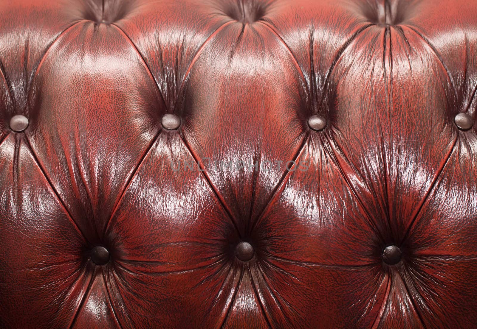 red-brown button-tufted leather background by Suriyaphoto