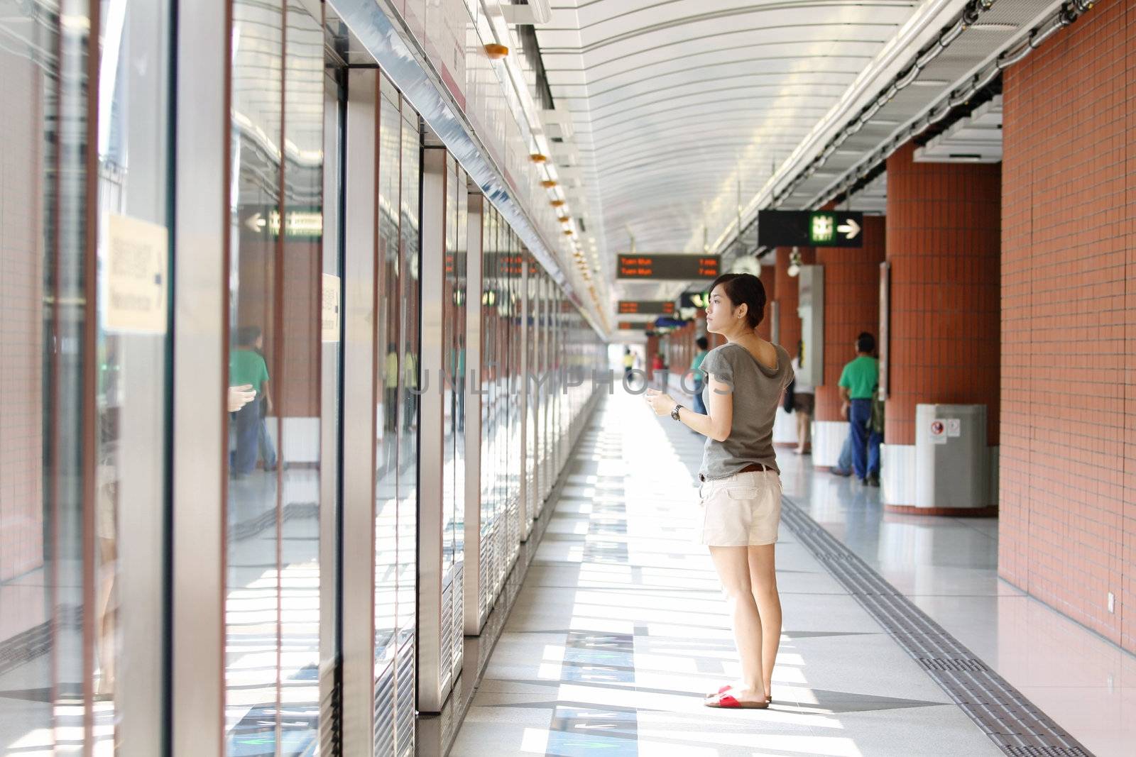 Asian woman waiting for train 