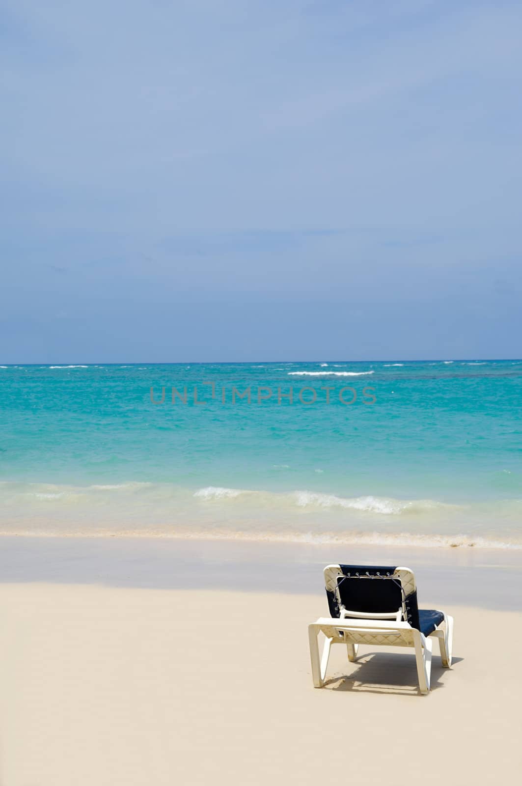 A sunbed near the water at exotic beach. Dominican Republic, Punta Cana.