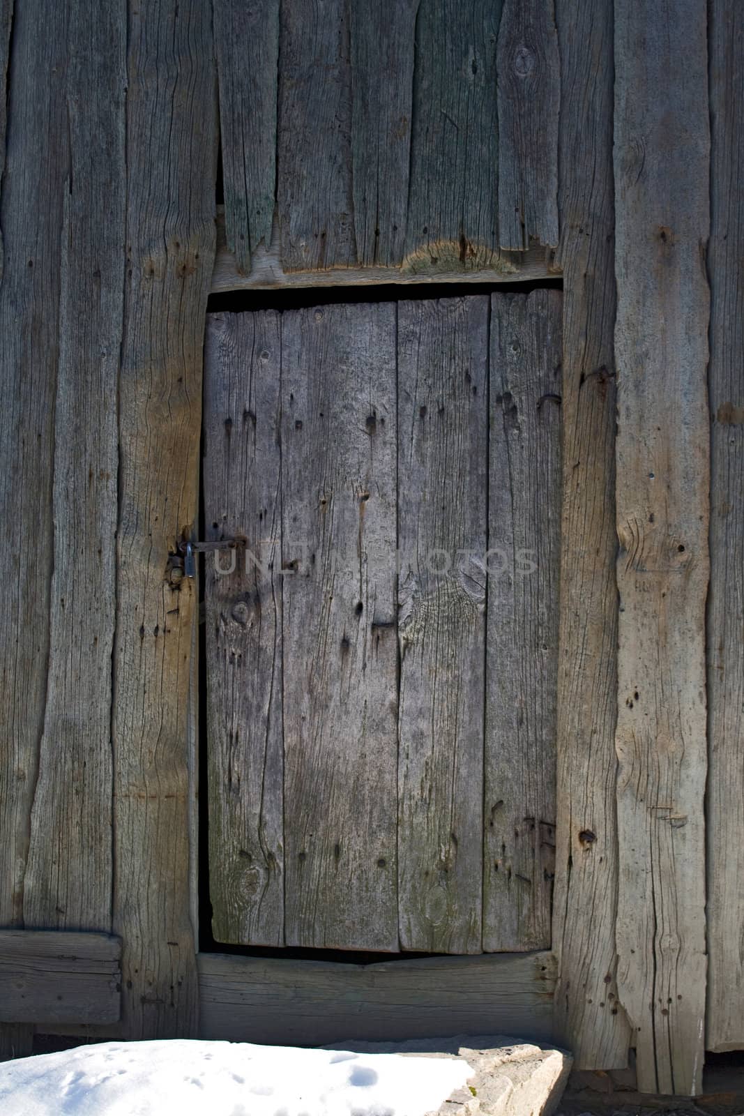 Old wooden door with rosty lock