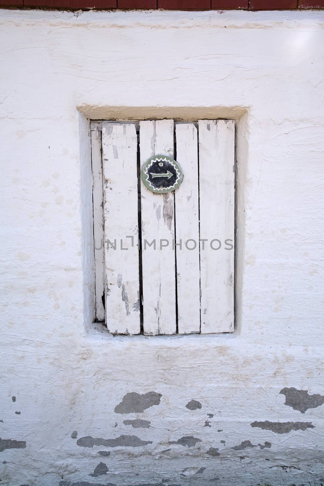 Old wooden door with arrow signal