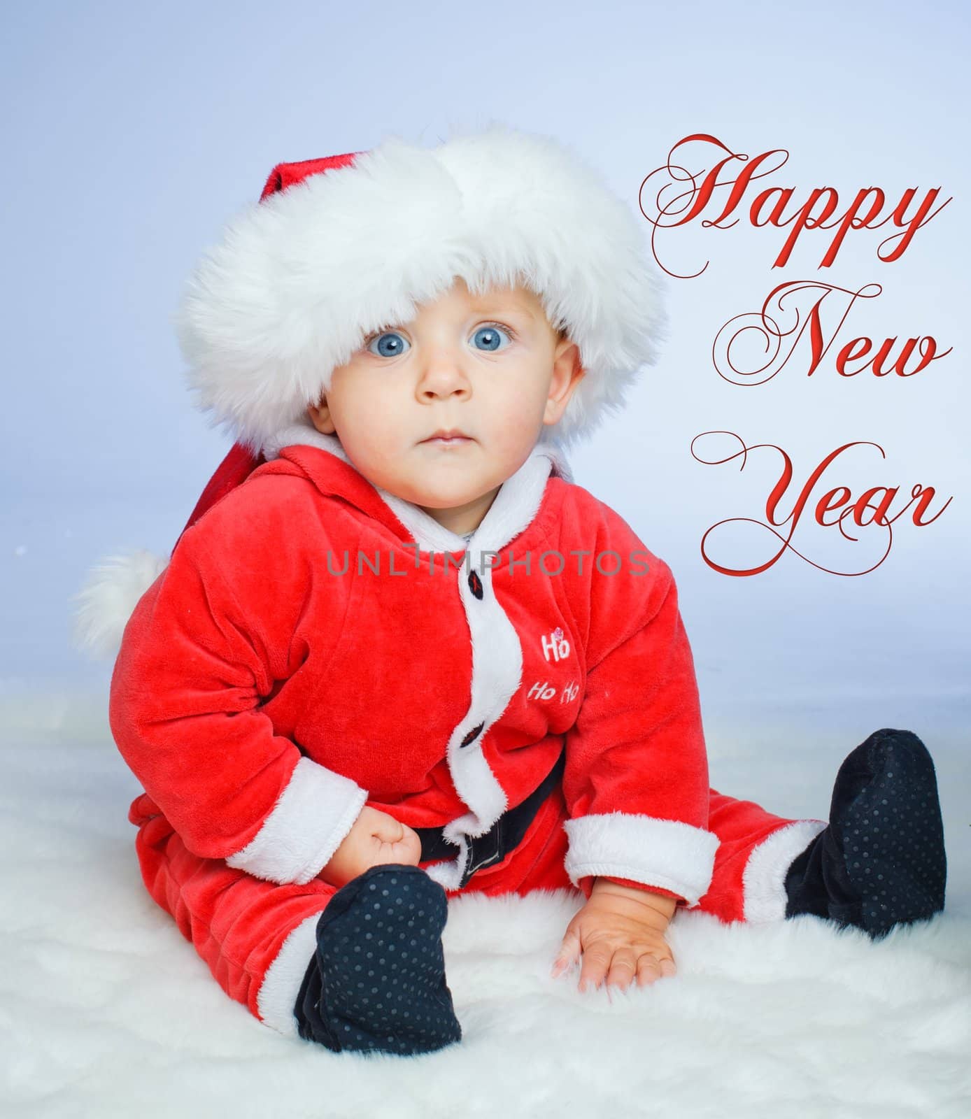 Surprised baby boy in santa claus hat