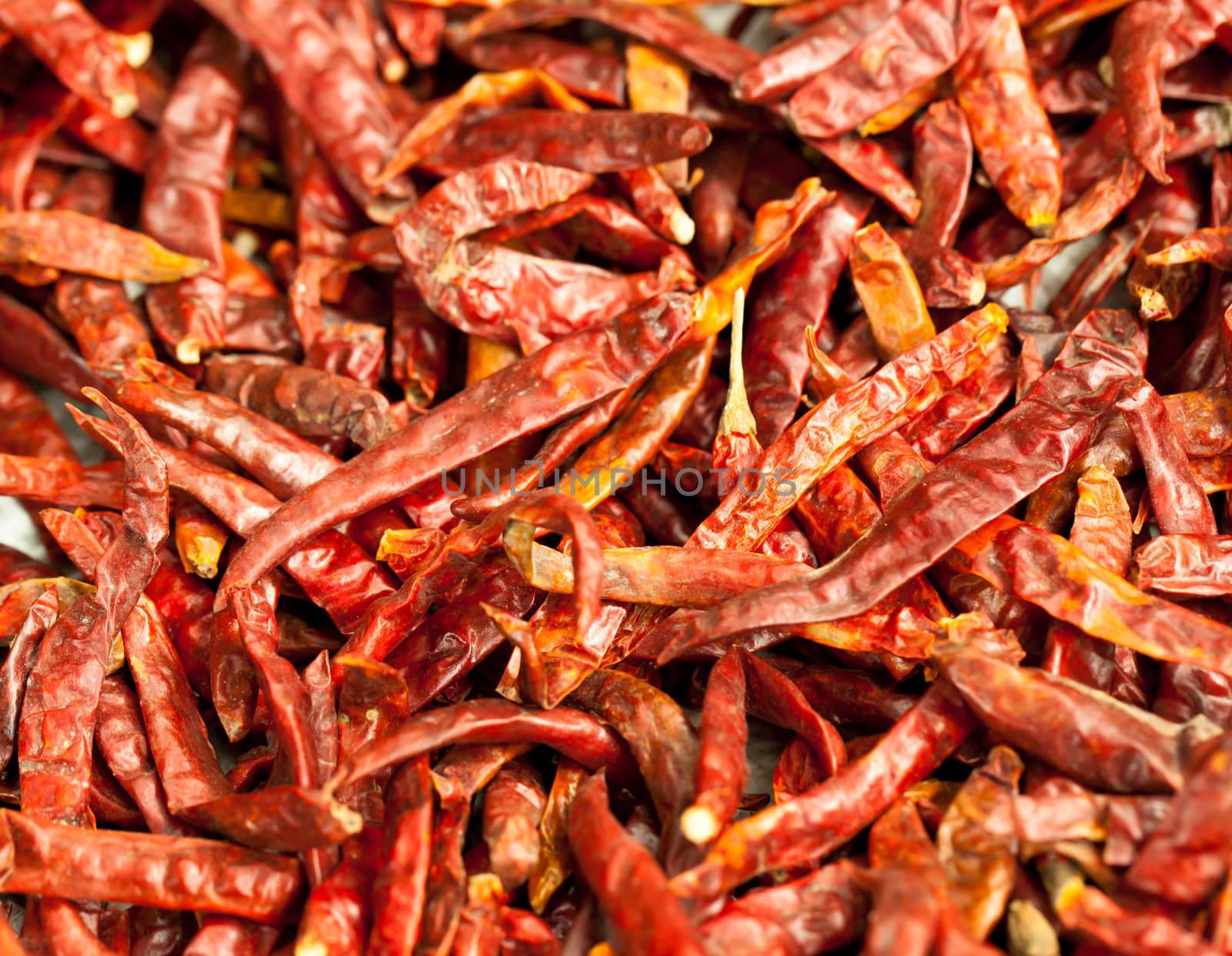 Isolate Dried chilli peppers background by Suriyaphoto