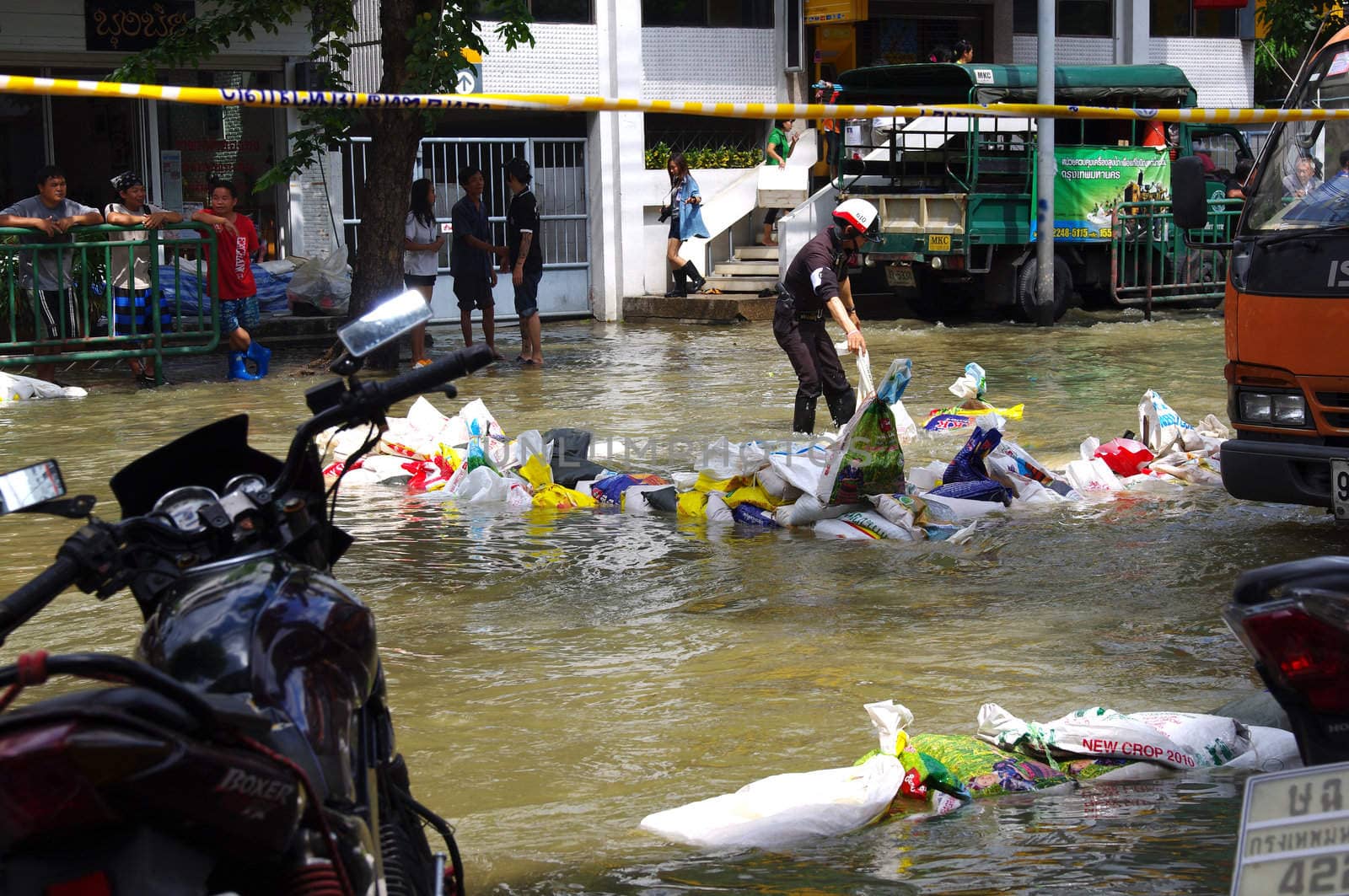 BANGKOK - OCT 30: Unidentified residents of Bangkok's Samsen road  Dusit district make their way through flooded streets after the Chao Phraya River bursts its banks on Oct 30, 2011 in Bangkok, Thailand.