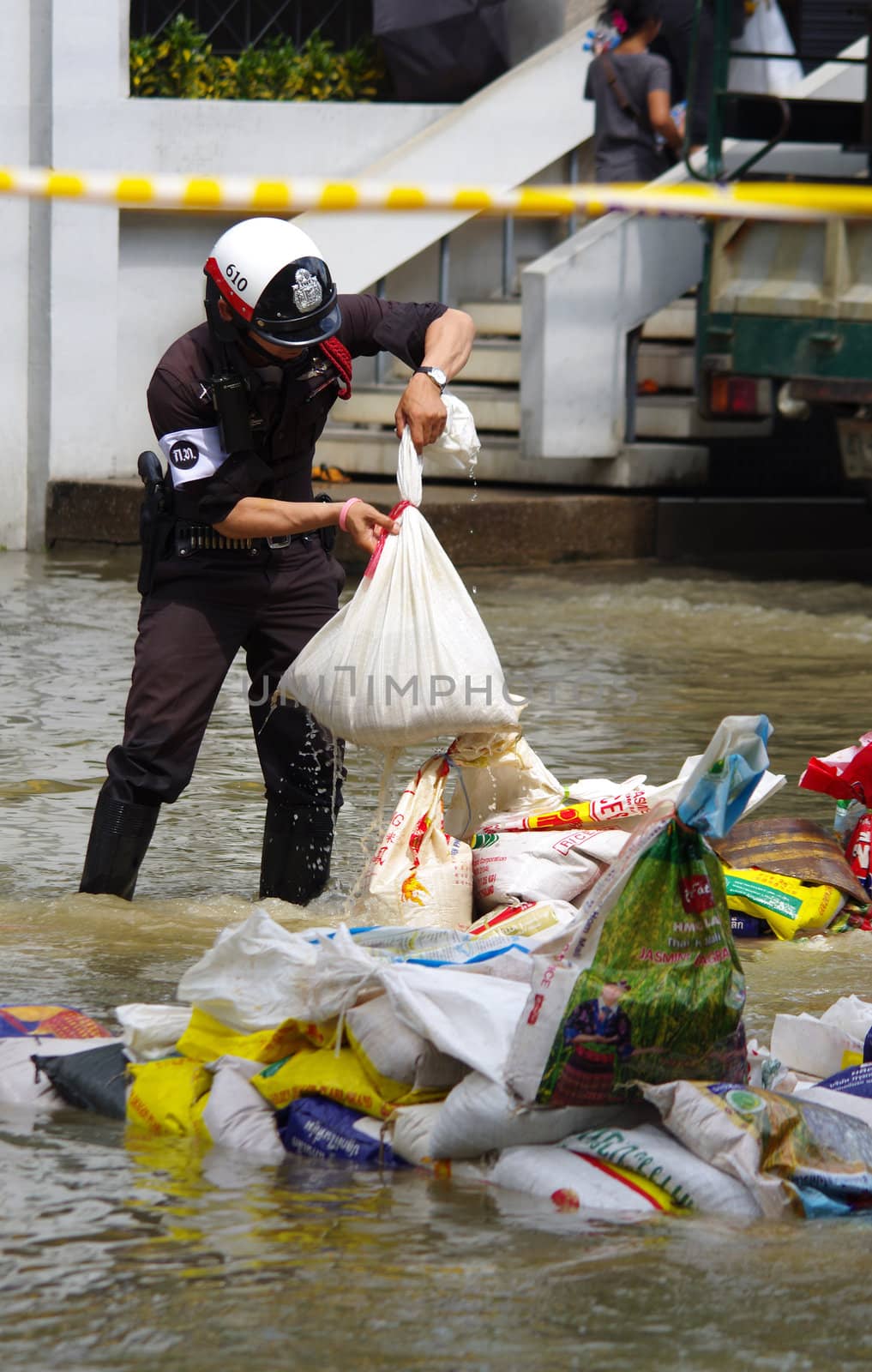 BANGKOK - OCT 30: Unidentified residents of Bangkok's Samsen road  Dusit district make their way through flooded streets after the Chao Phraya River bursts its banks on Oct 30, 2011 in Bangkok, Thailand.