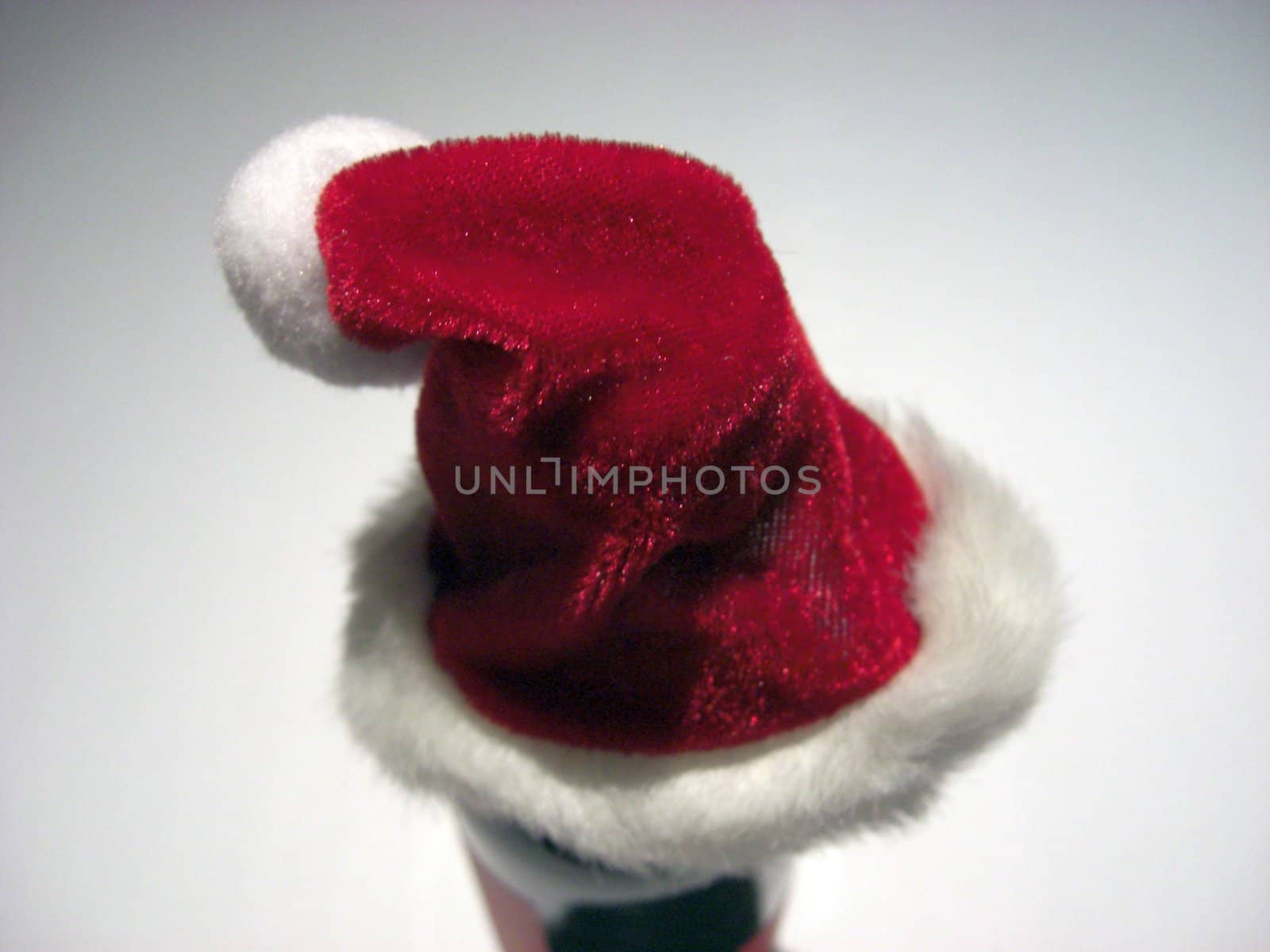 Santa Claus hat with white pompom on light background