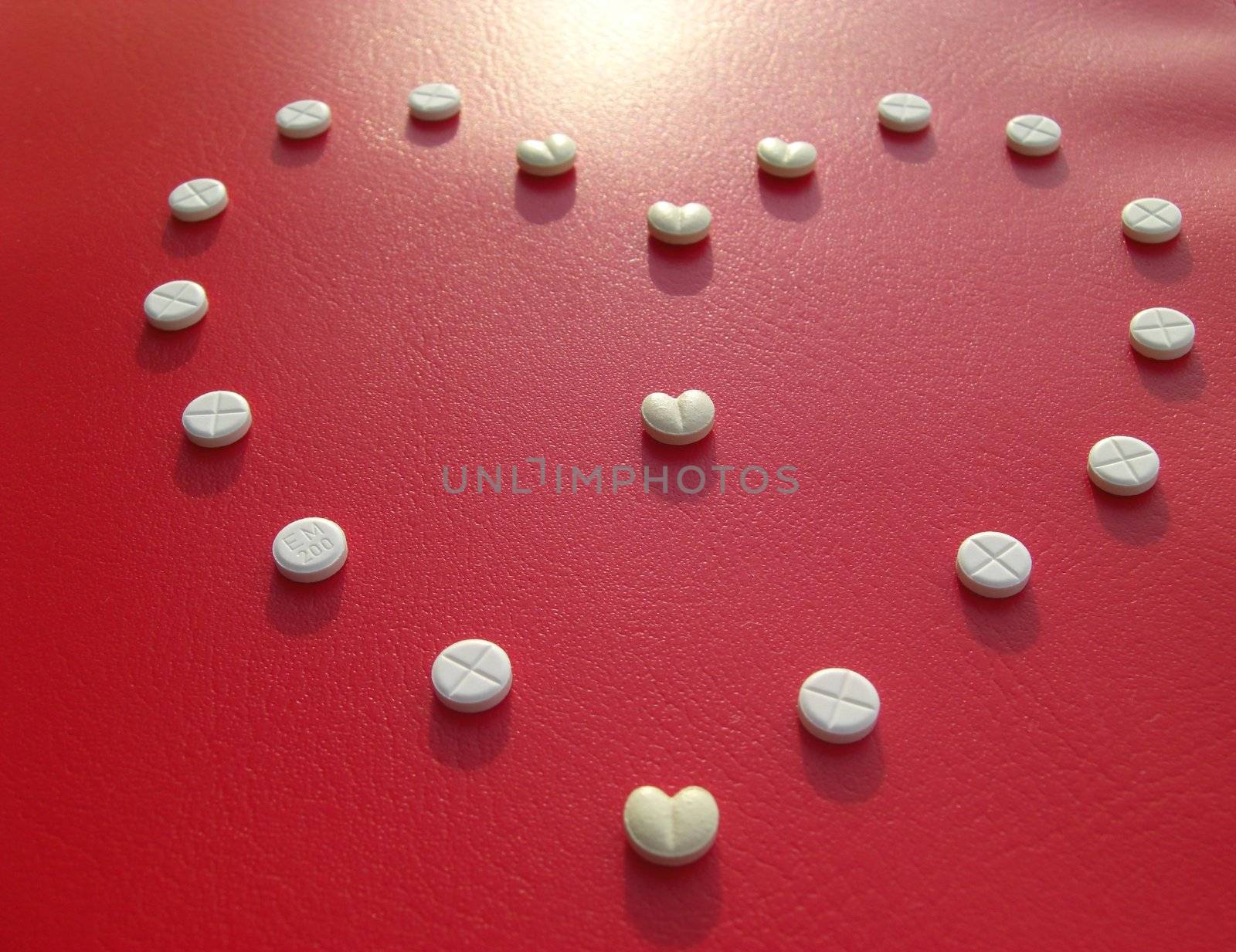 pills on red, heart-shaped disposition