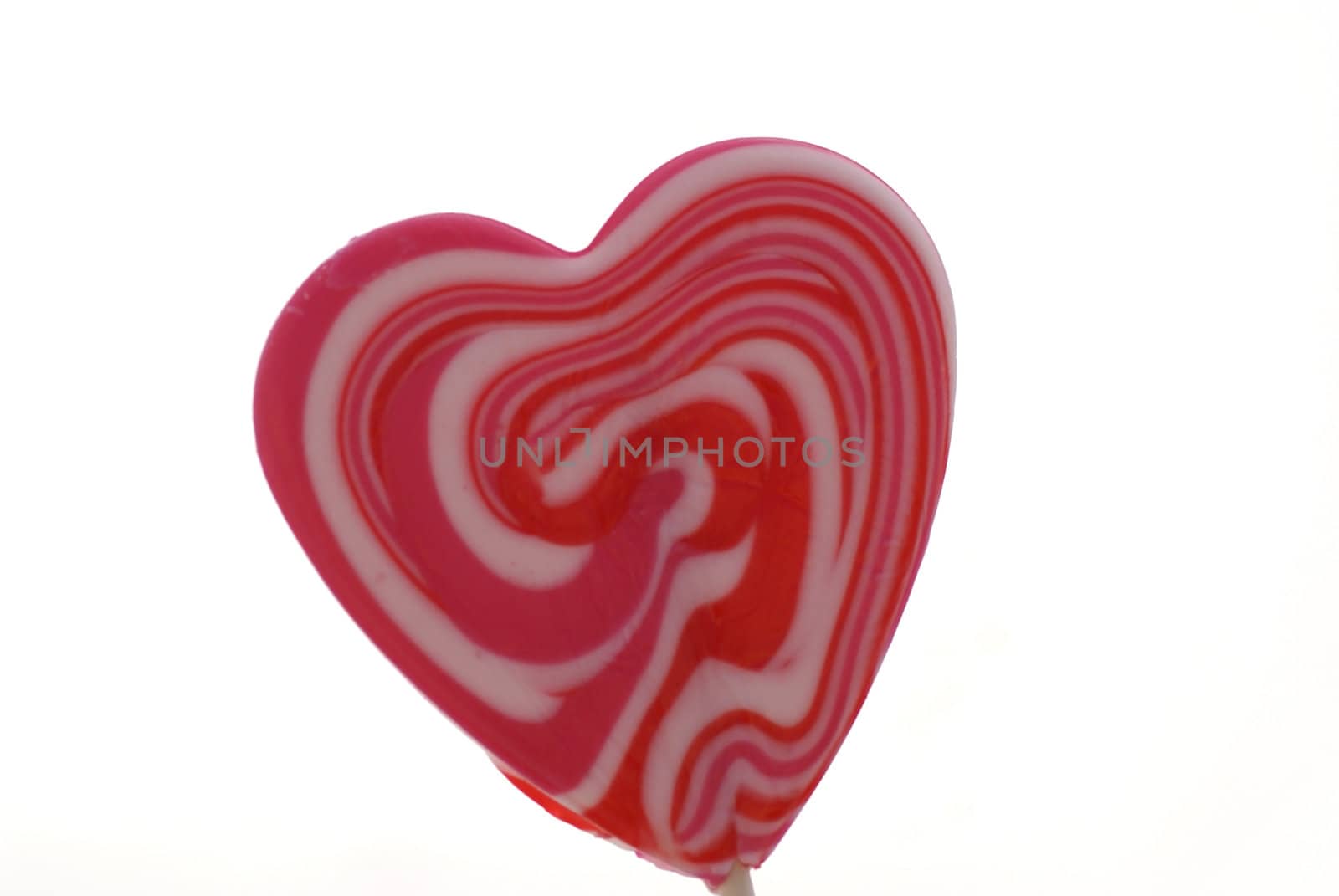 Heart shaped lollypop isolated on white.