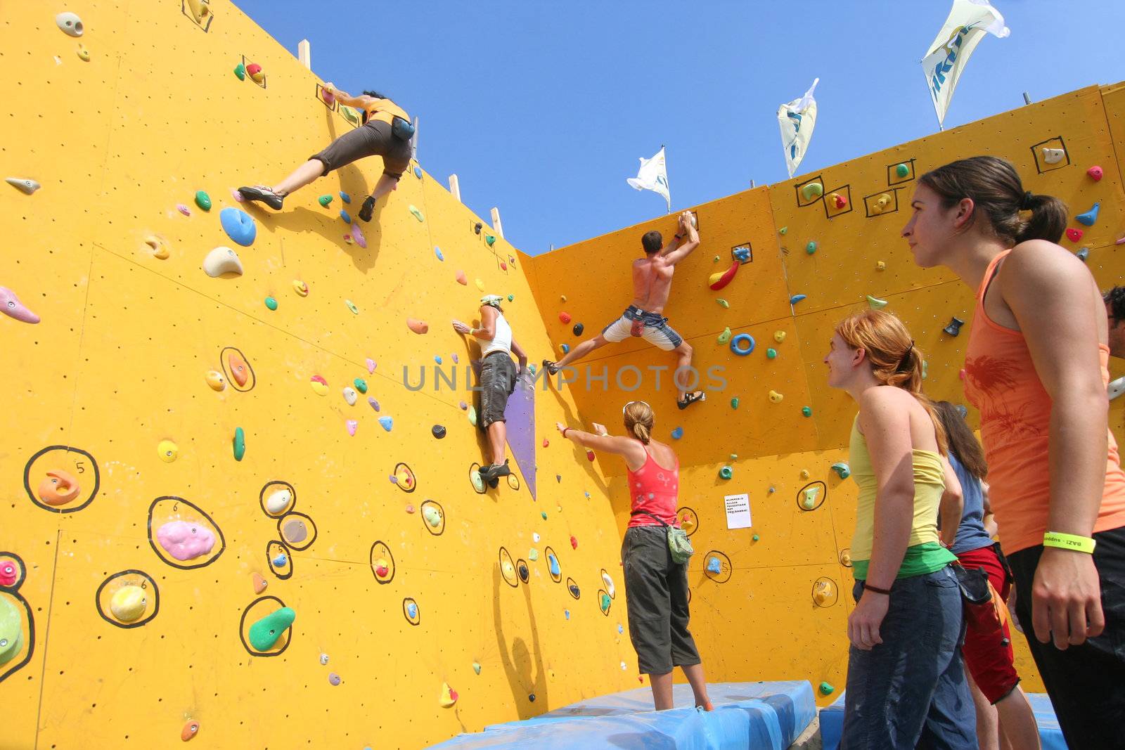 Annual Bouldering Competition on Scheveningen beach. Participants climbing artificial rock face.