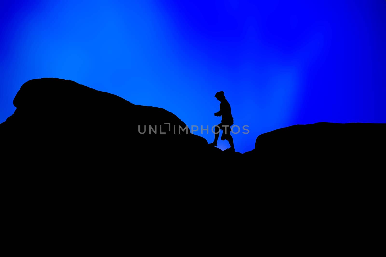 Silhouettes of people on a hill