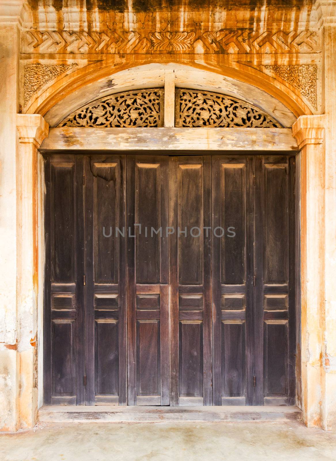 Old wood door in a old wall