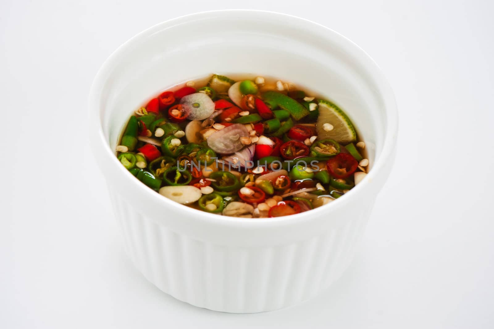 Hot spice chili fish sauce in a ramecin on white background