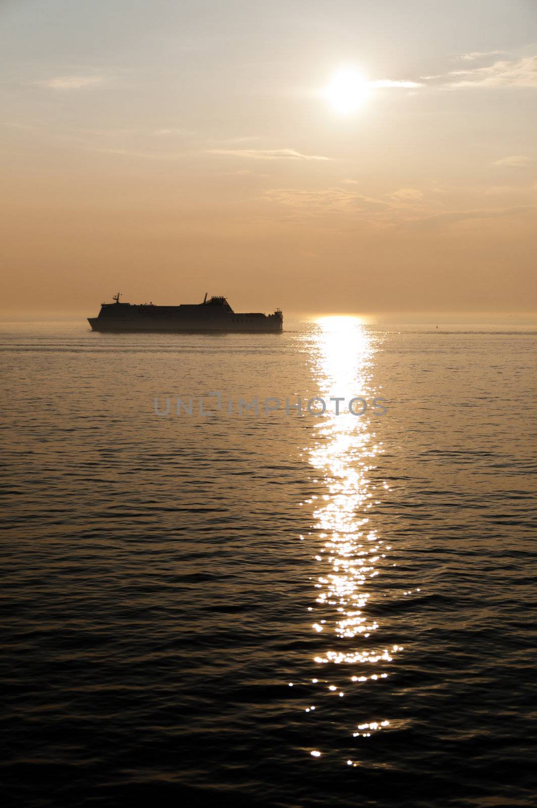 a large cruise ship in a beautiful sunset