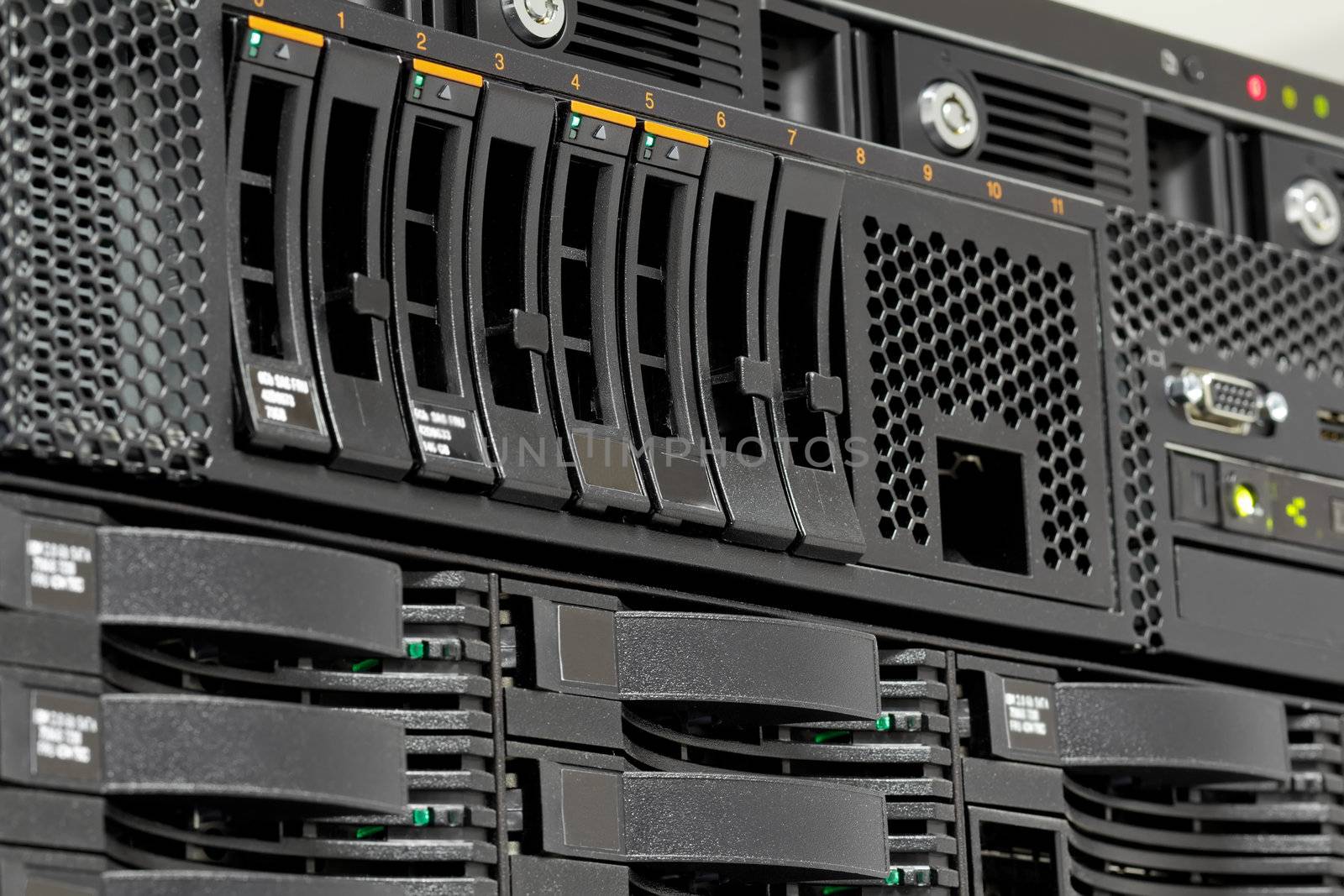servers stack with hard drives in a datacenter by artush