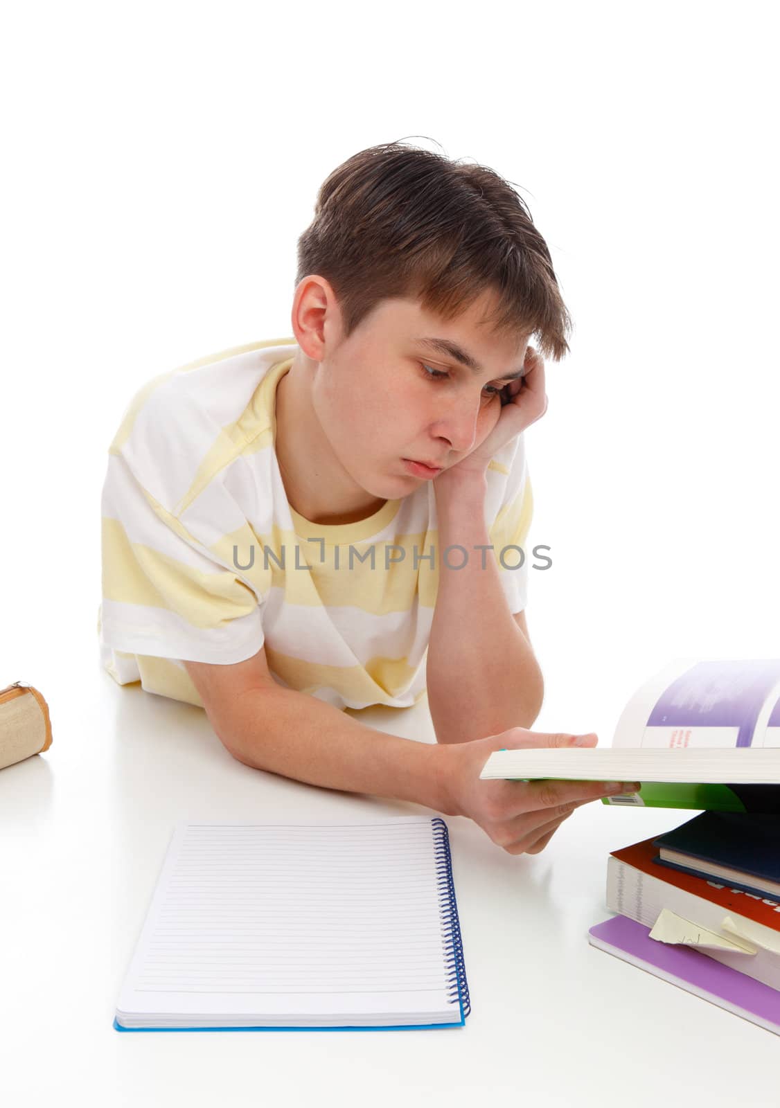 A boy reading or studying textbooks.