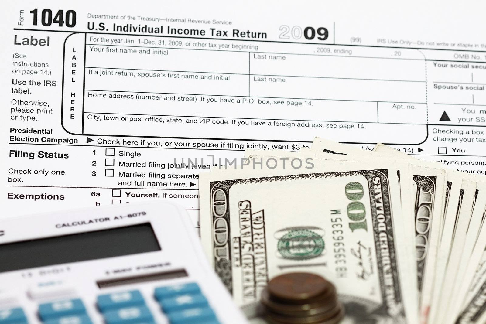 1040 tax form with calculator and dollars.