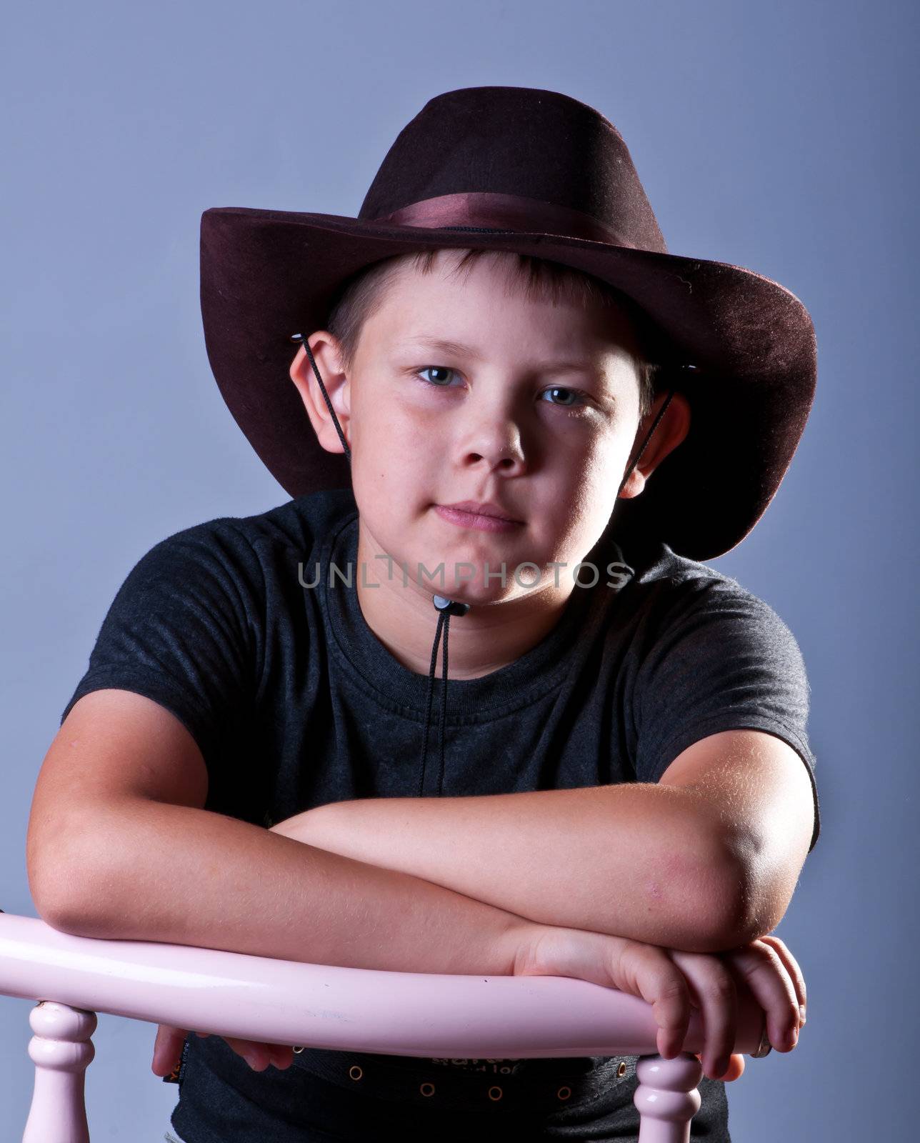 Young boy. Portrait in studio on a grey background.