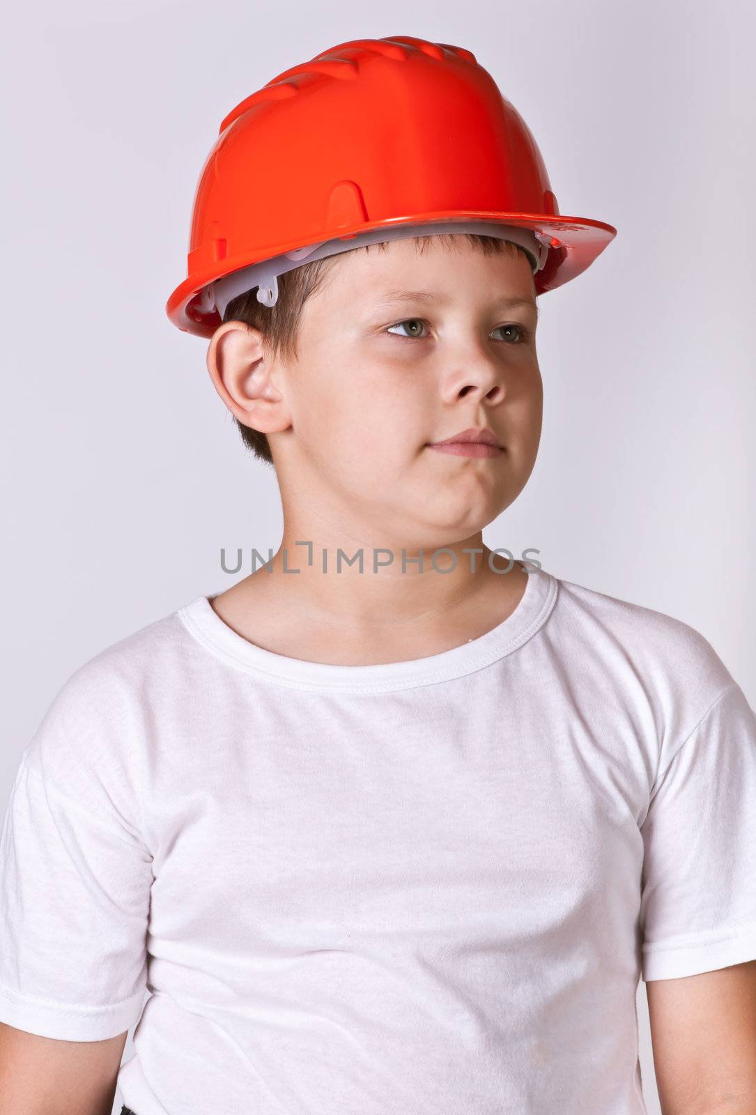 Portrait of a boy in a red protective helmet