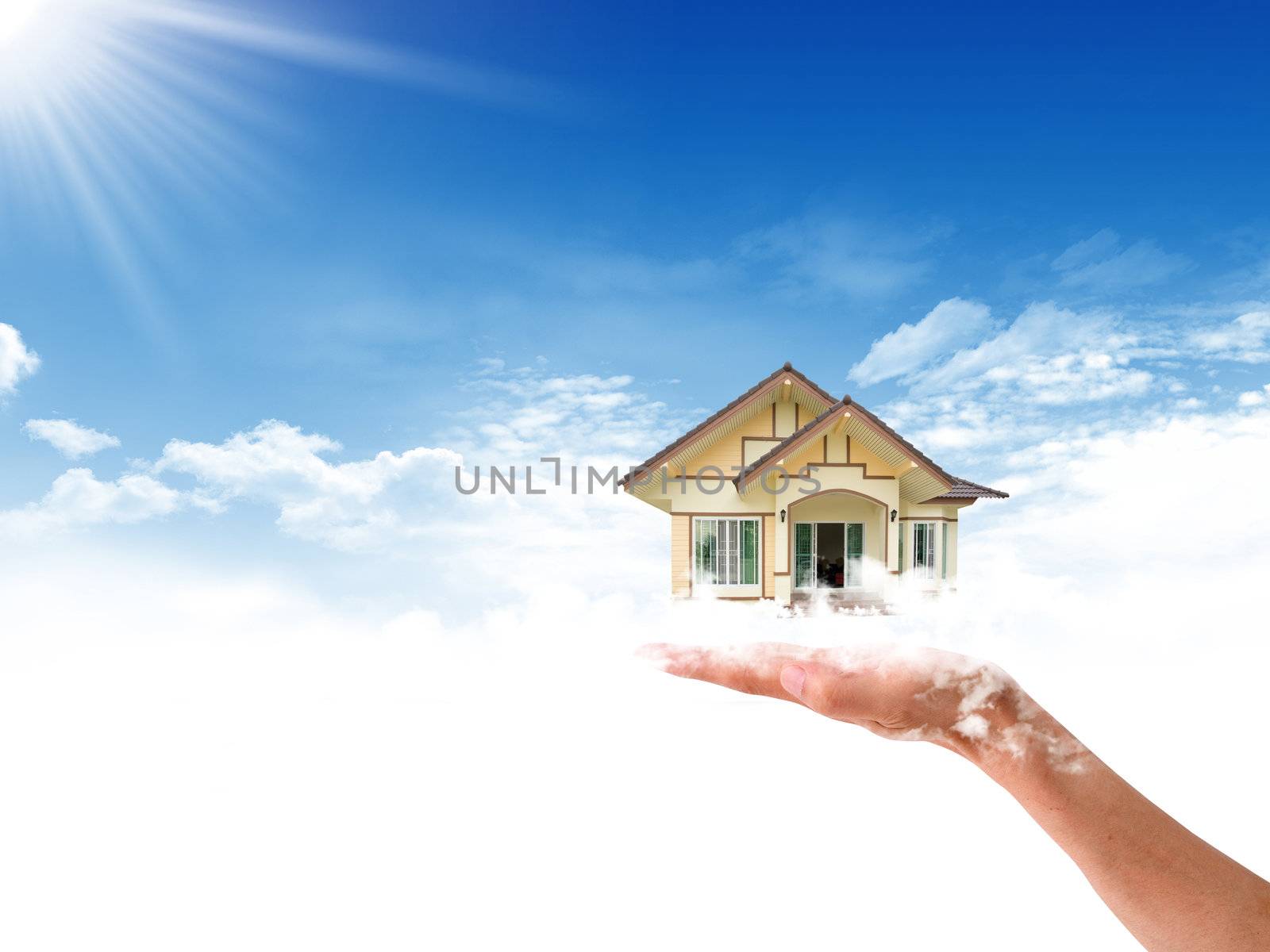 The House in the hands against the blue sky