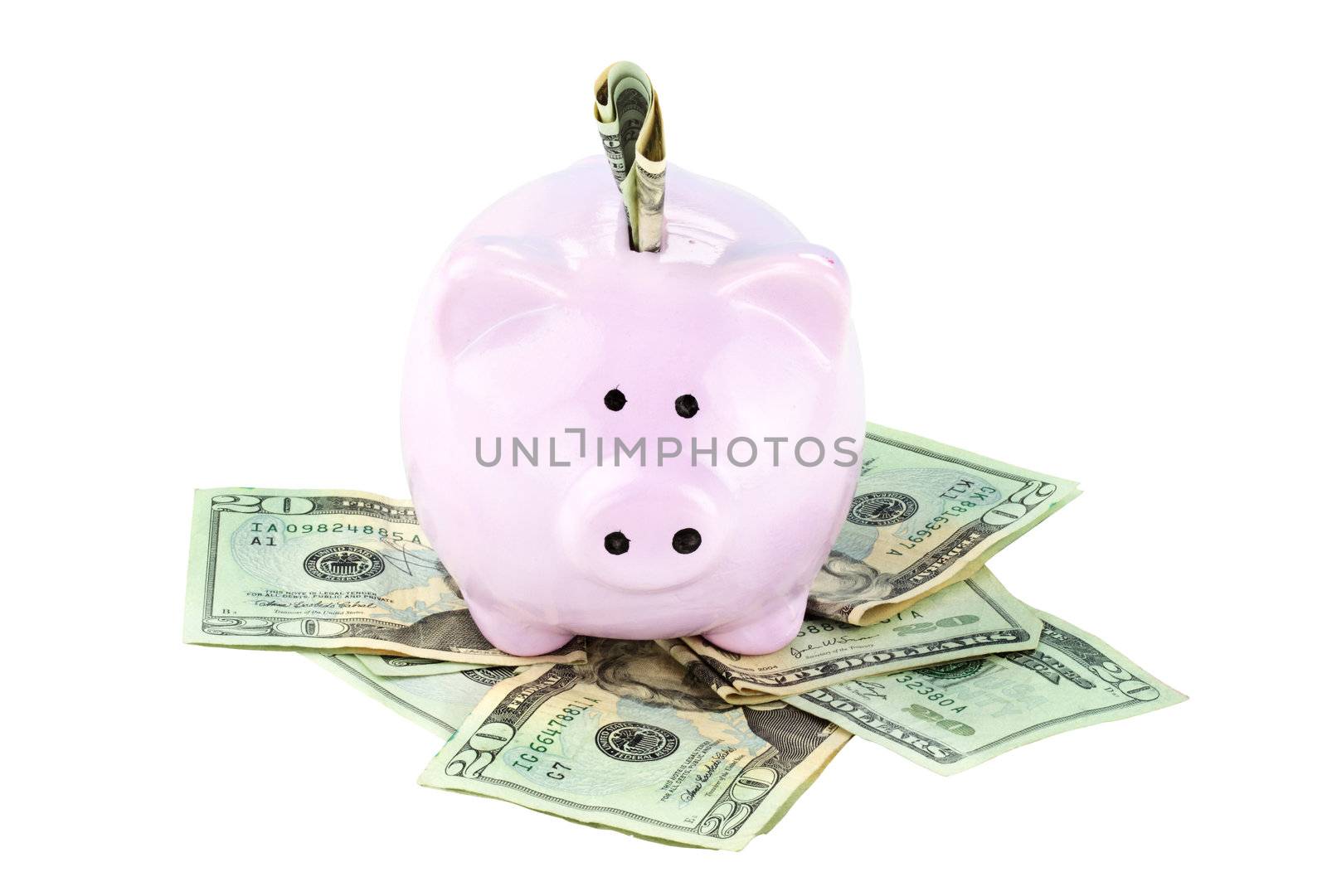 Pink piggy bank and cash isolated on a white background with clipping path included.

