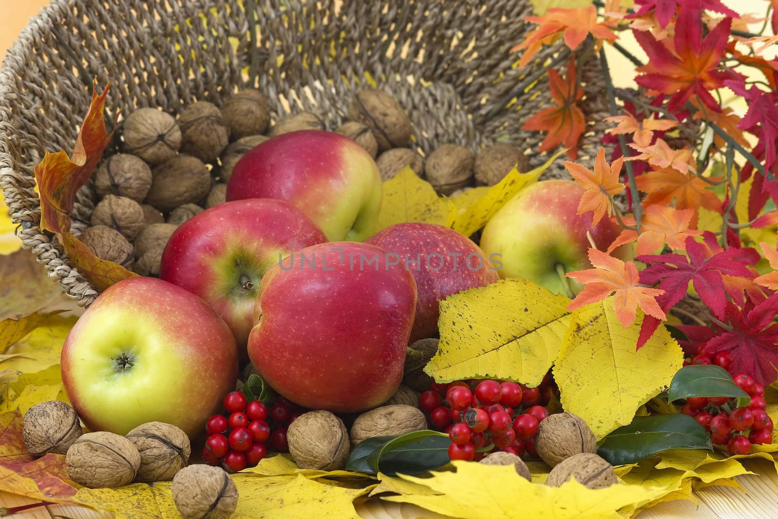 beautiful arrangement of autumn leaves and red apples and walnuts