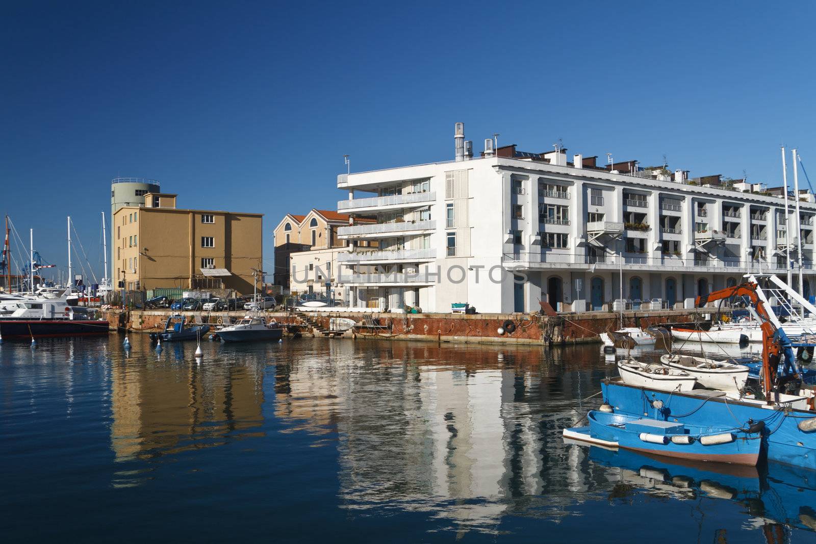warehouse, fishing boat and sail boat in Genoa port, Italy
