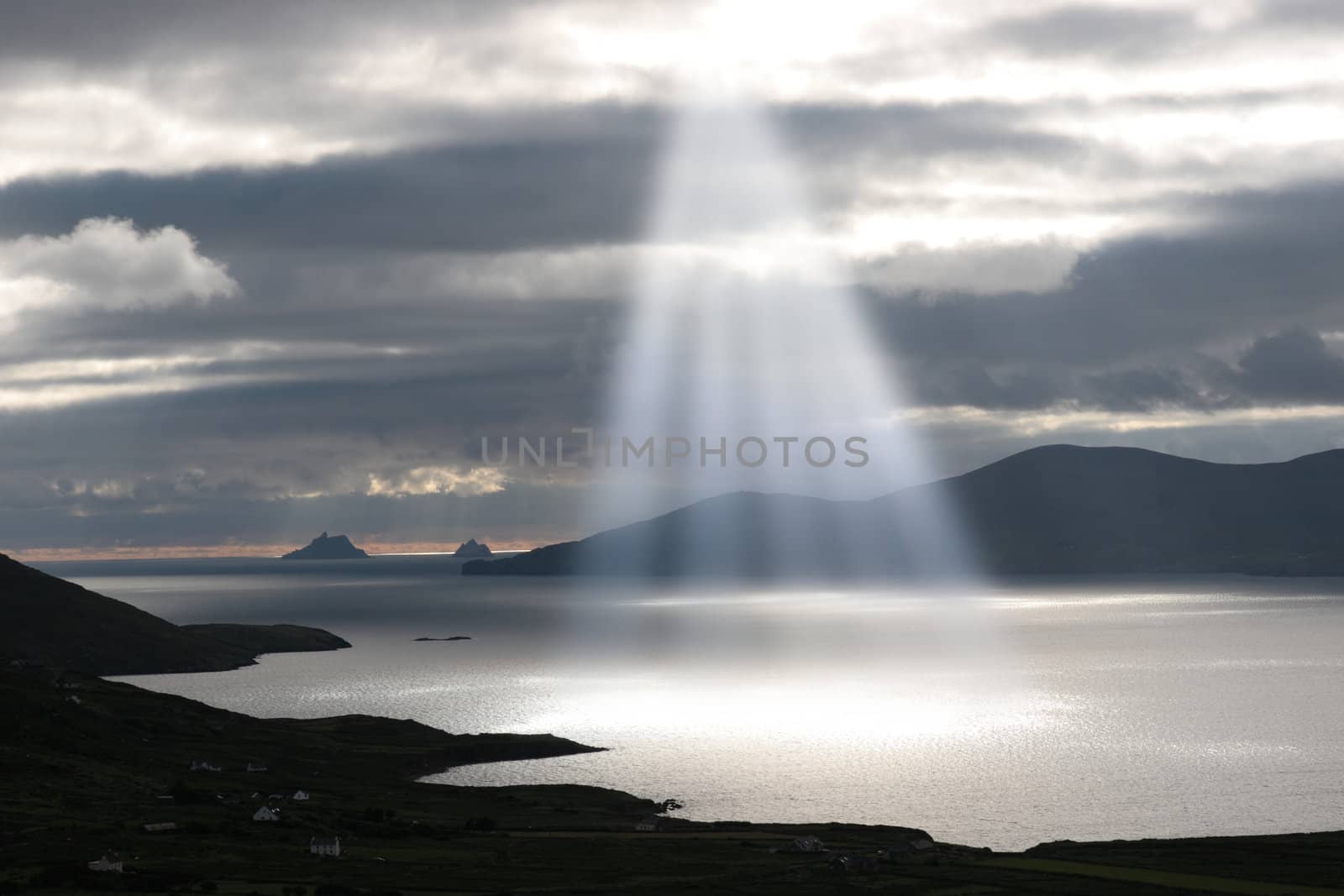 kerry scenic view of the Skellig rocks in ireland with mountains against a beautiful blue cloudy sky