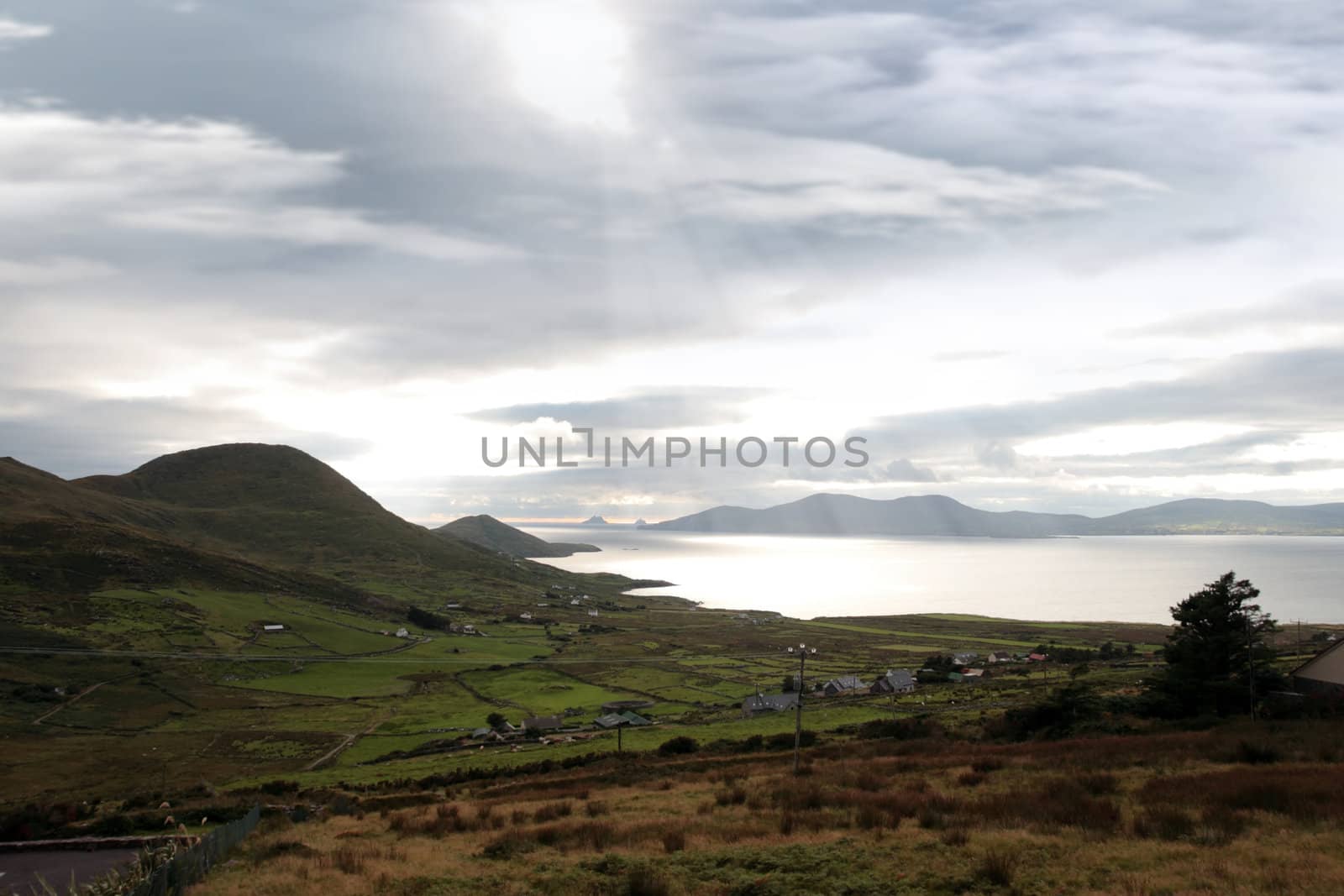 kerry scenic view of the Skellig rocks in ireland with mountains against a beautiful blue cloudy sky