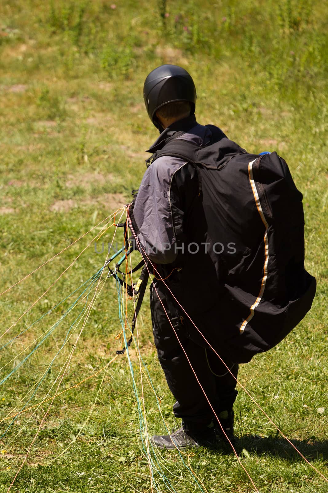 A Paraglider flying from a mountain on a warm summer afternoon