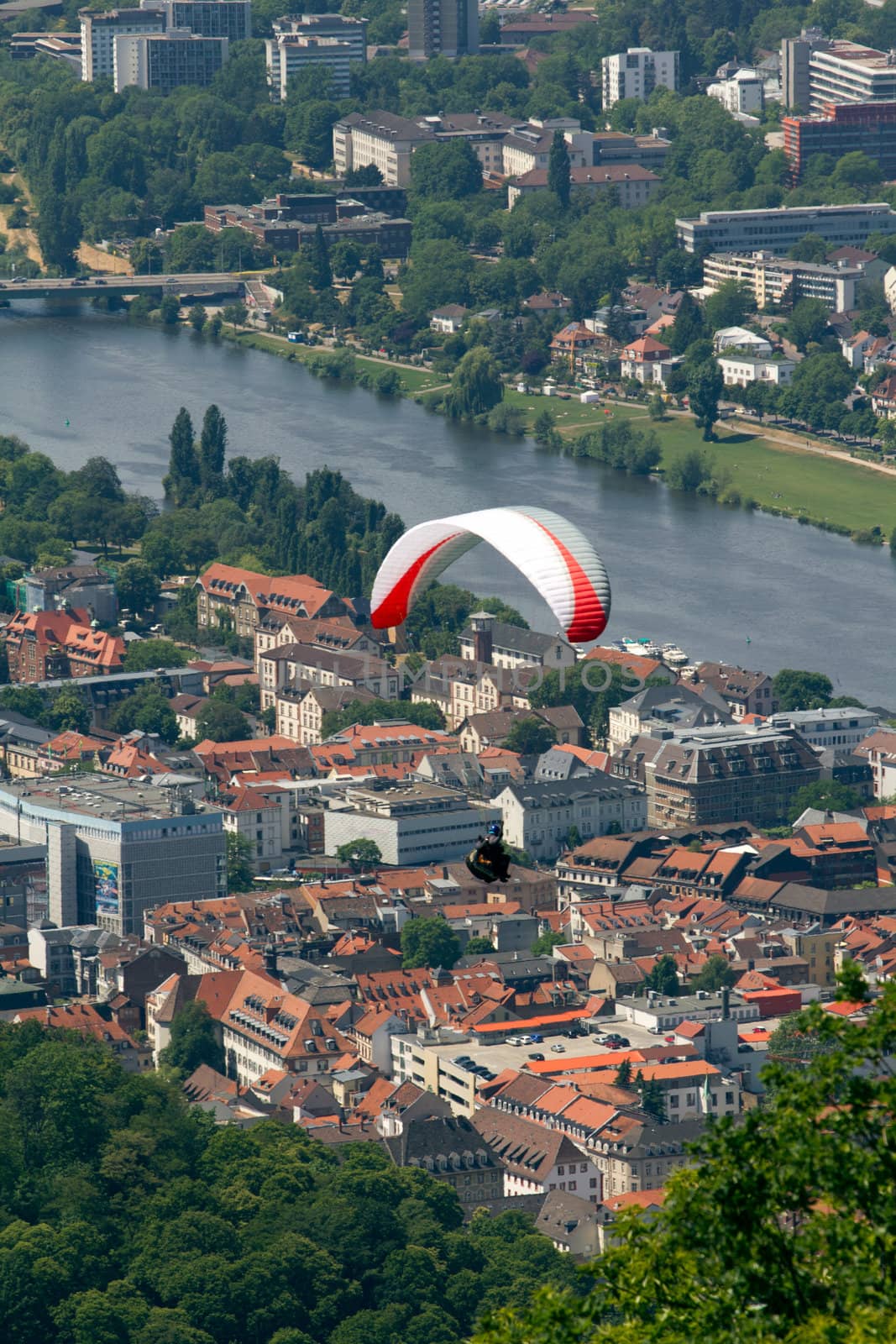 A Paraglider flying from a mountain on a warm summer afternoon