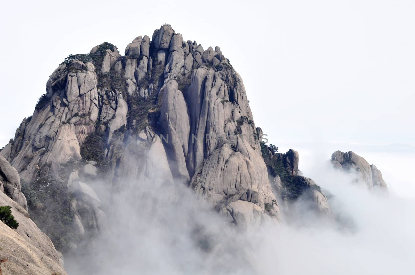 Landscape of rocky mountain peaks in a foggy morning