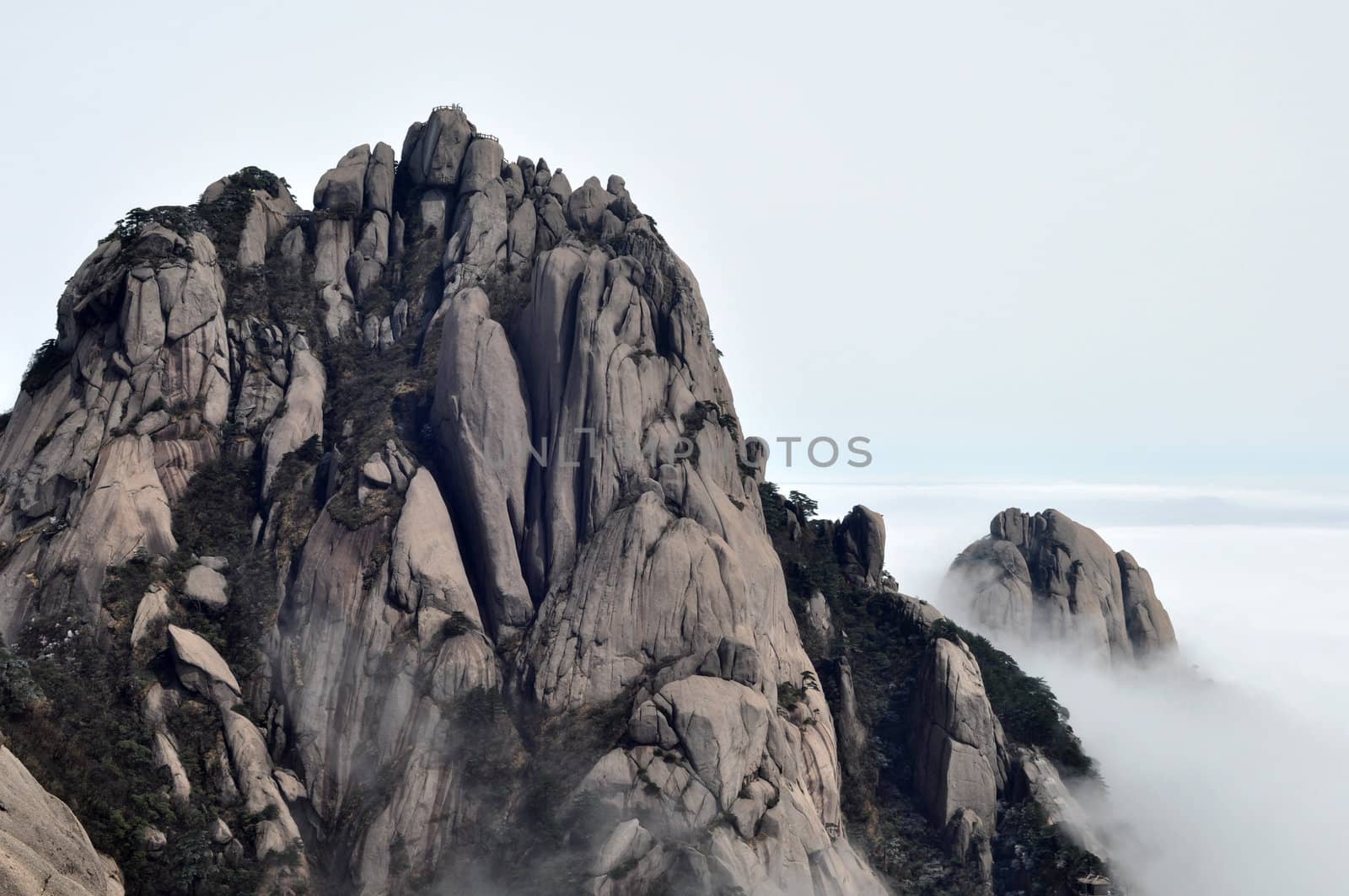 Landscape of rocky mountain peaks in a foggy morning