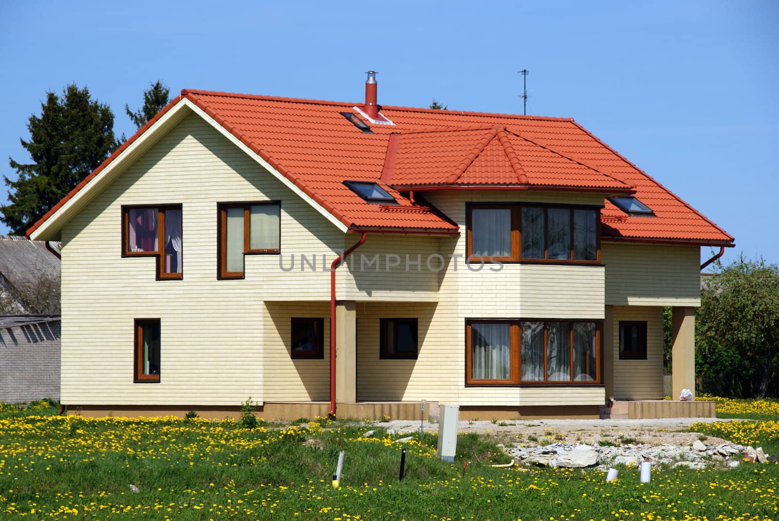 Modern apartment house on a background of a green grass