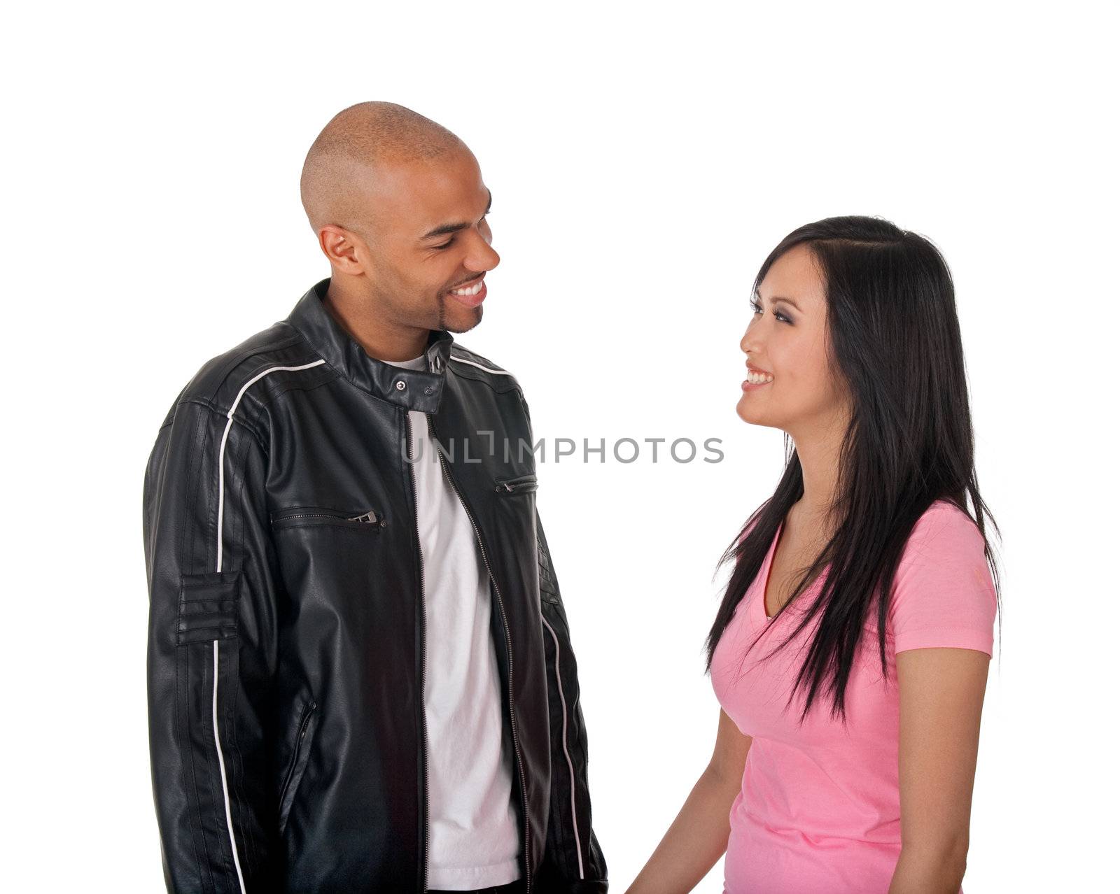 Young affectionate couple holding hands - African American guy with Asian girlfriend.