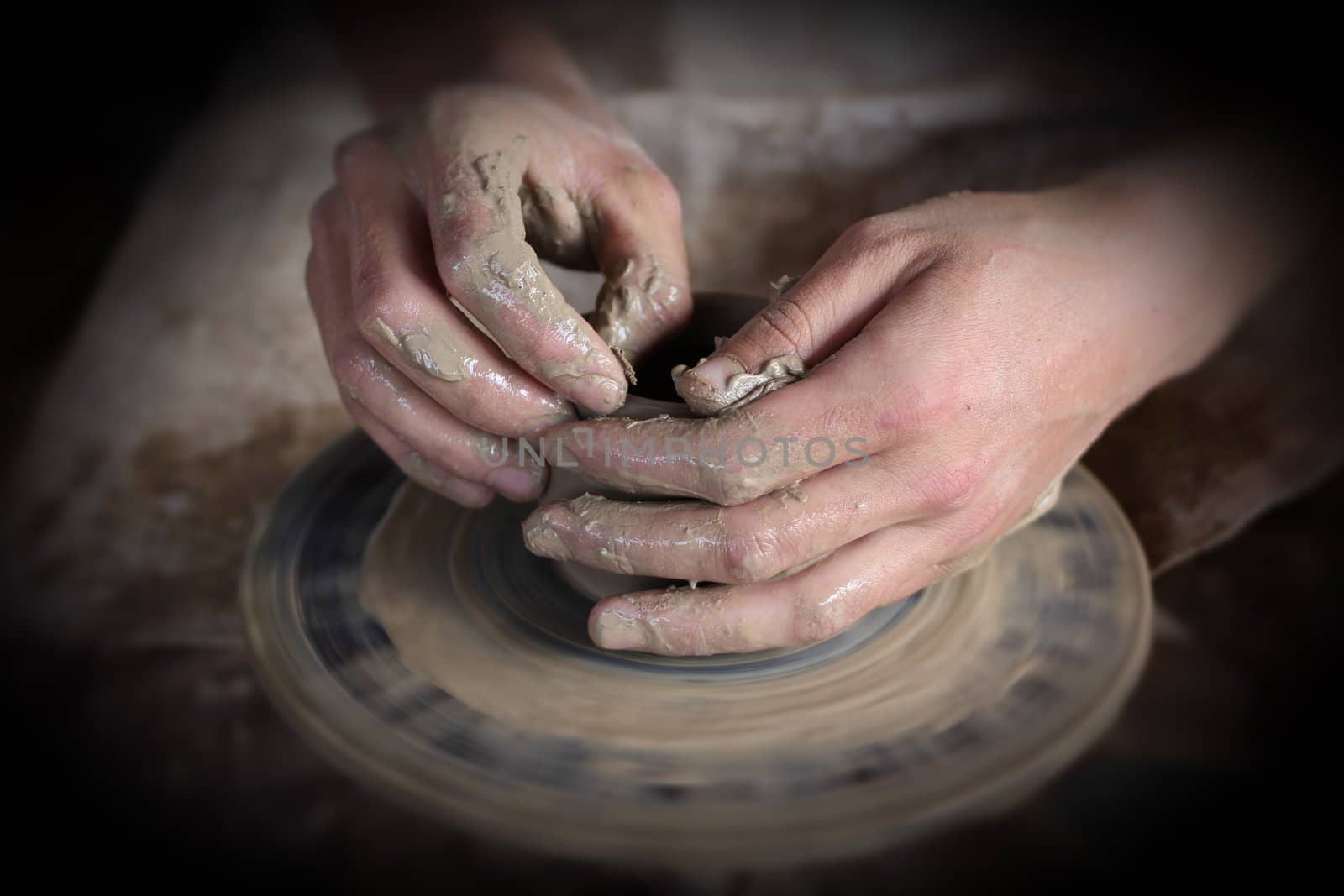 Hands of a potter. Loyalty to the traditions concept