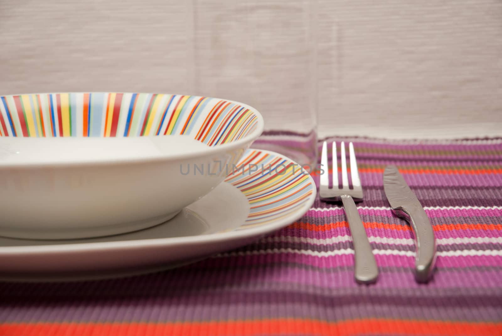 colored striped dishes and cutlery steel