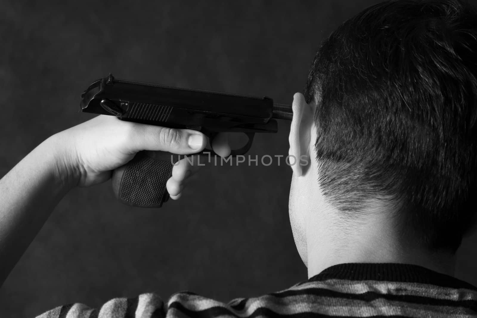 The man with a pistol on a dark background 