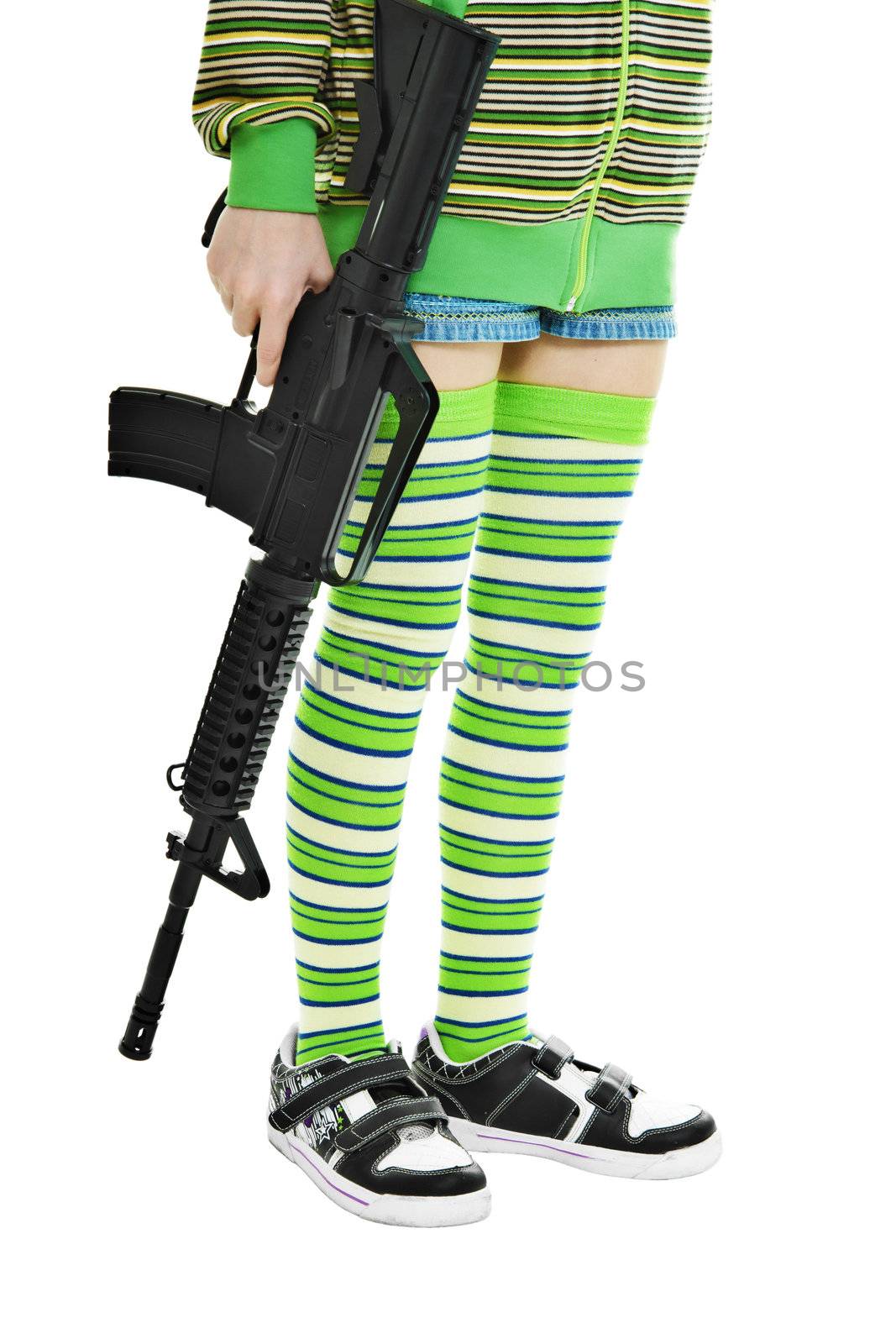 lower part of the teen girls in colorful clothes with a gun in his hand
