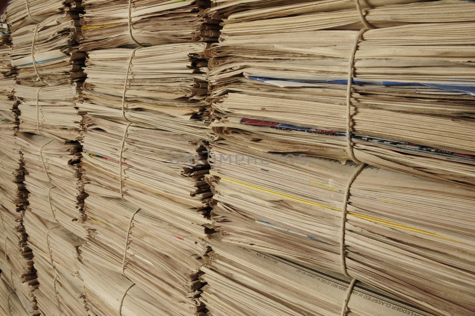 Close-up of piles of newspapers on an angle to be recycled