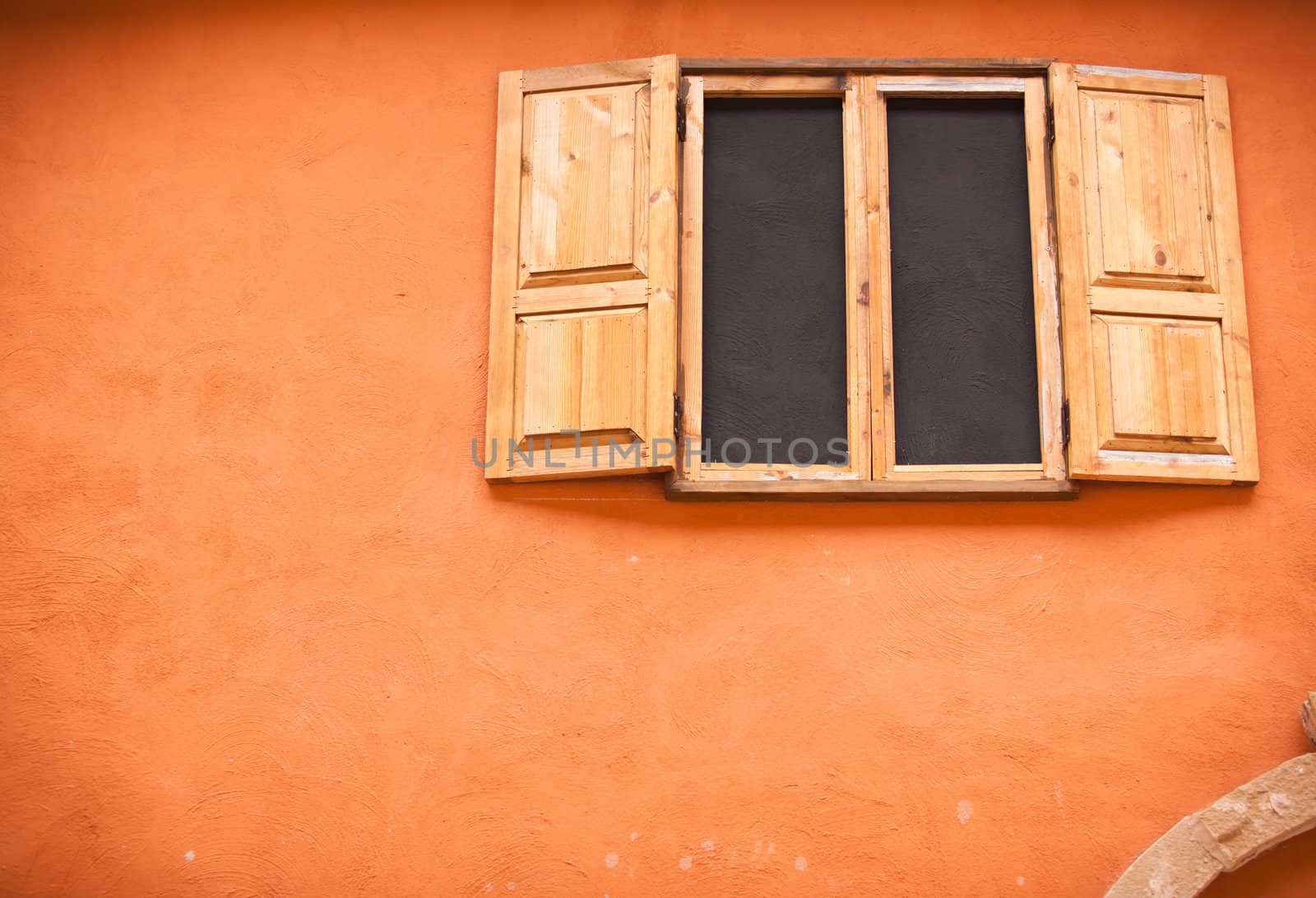 Vintage window on orange wall by Suriyaphoto