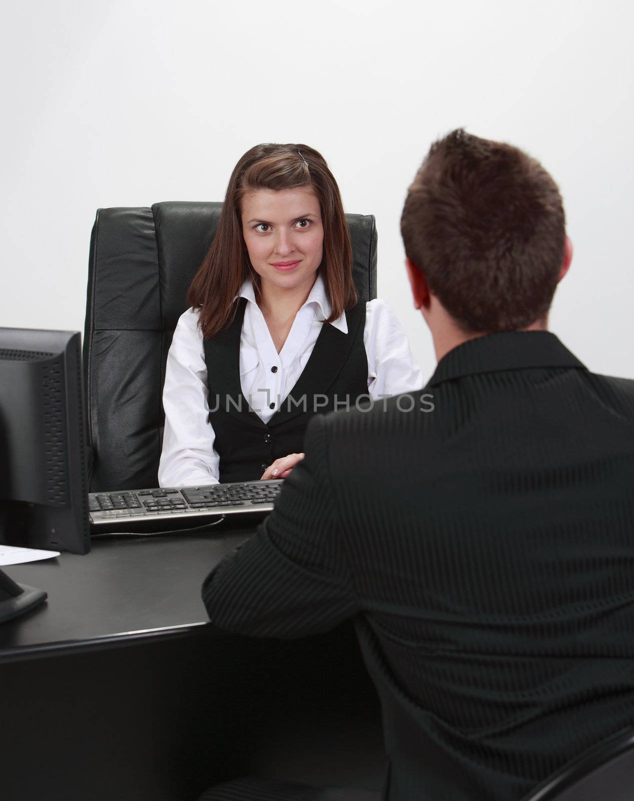 A businessman and a businesswoman at an interview in an office.