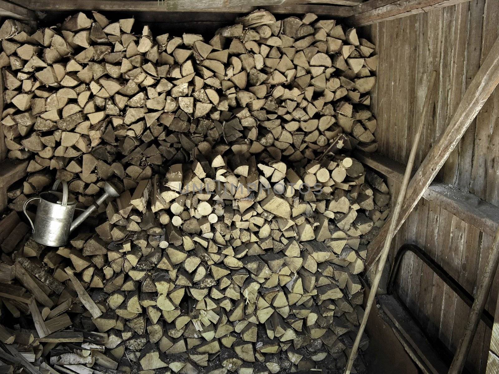 Stacked chopped firewood  woodpile inside a rural cottage