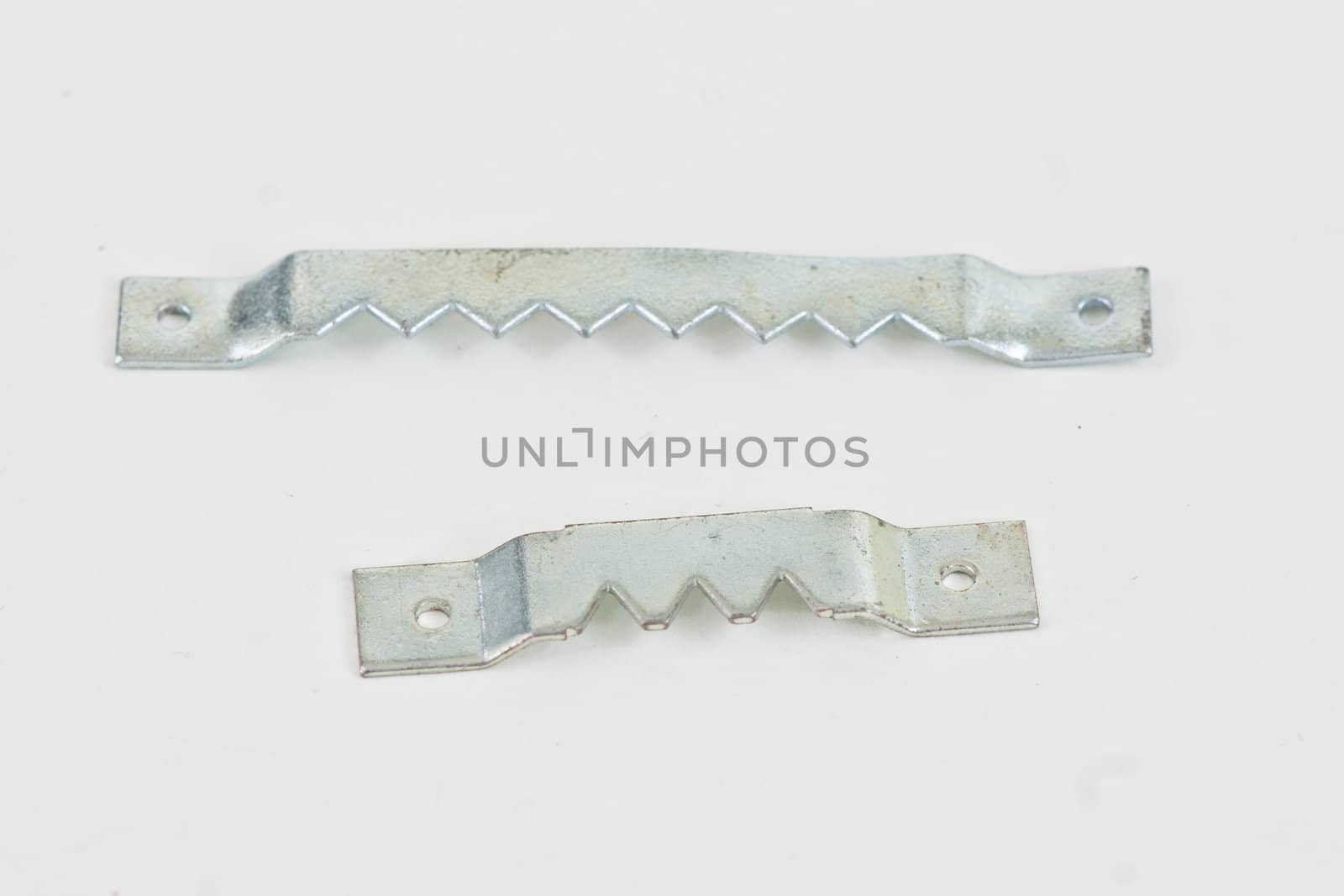 Two different sizes of saw thooth picture hangers on a white background.