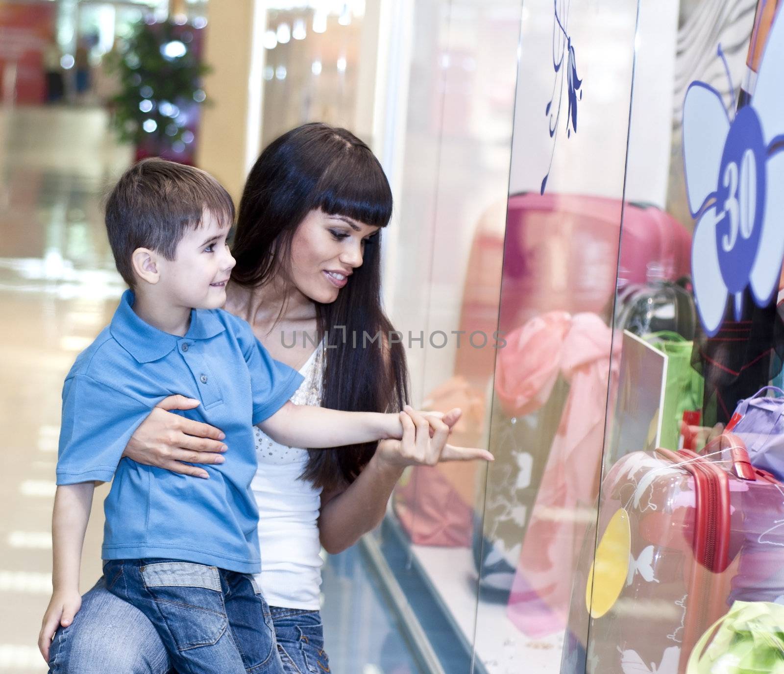 Mum and the son discuss purchases in shopping center