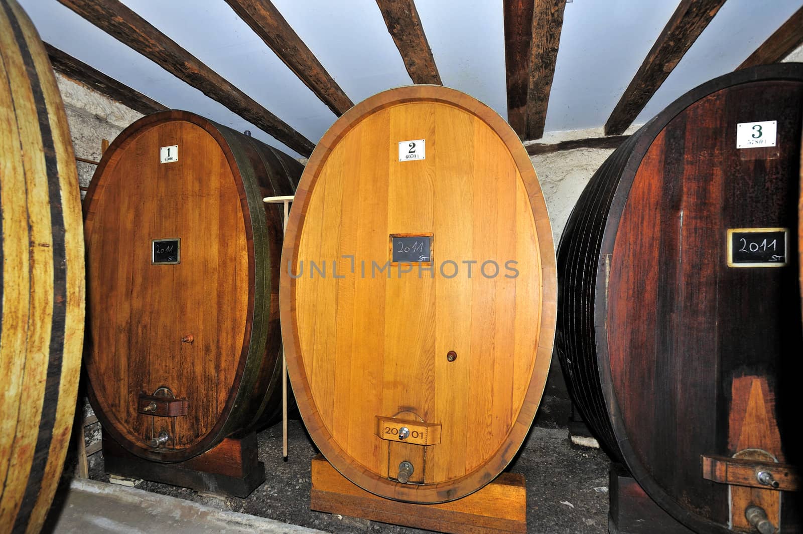 Traditional oaken barrels of fermenting wine in a Swiss wine-producer's cellar (cave). The Swiss do produce wine, lots of it. It's little known because they drink most of it themselves. Less than 2% is exported.
