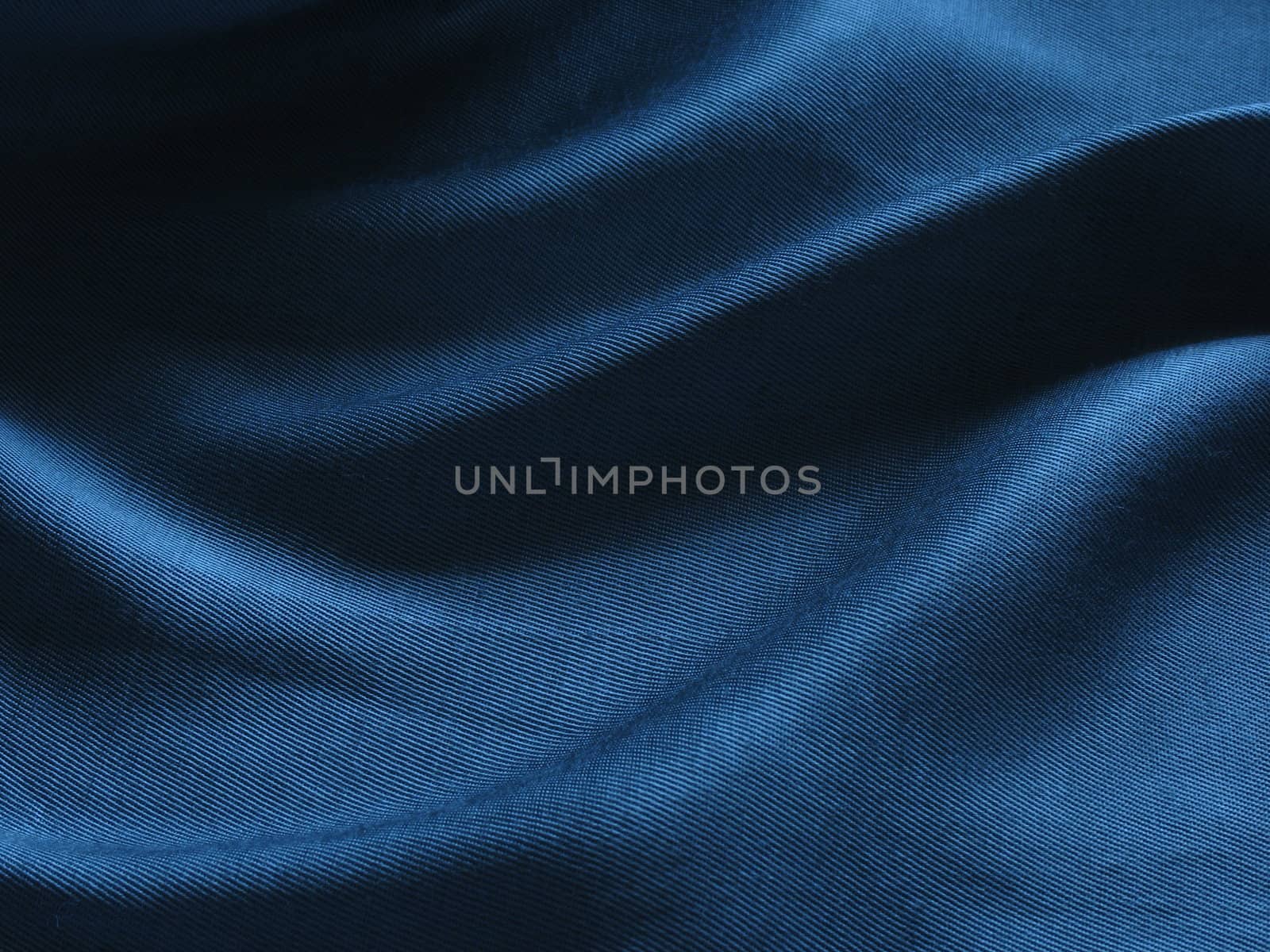 Abstract blue silk background, cloth is bedded by waves 