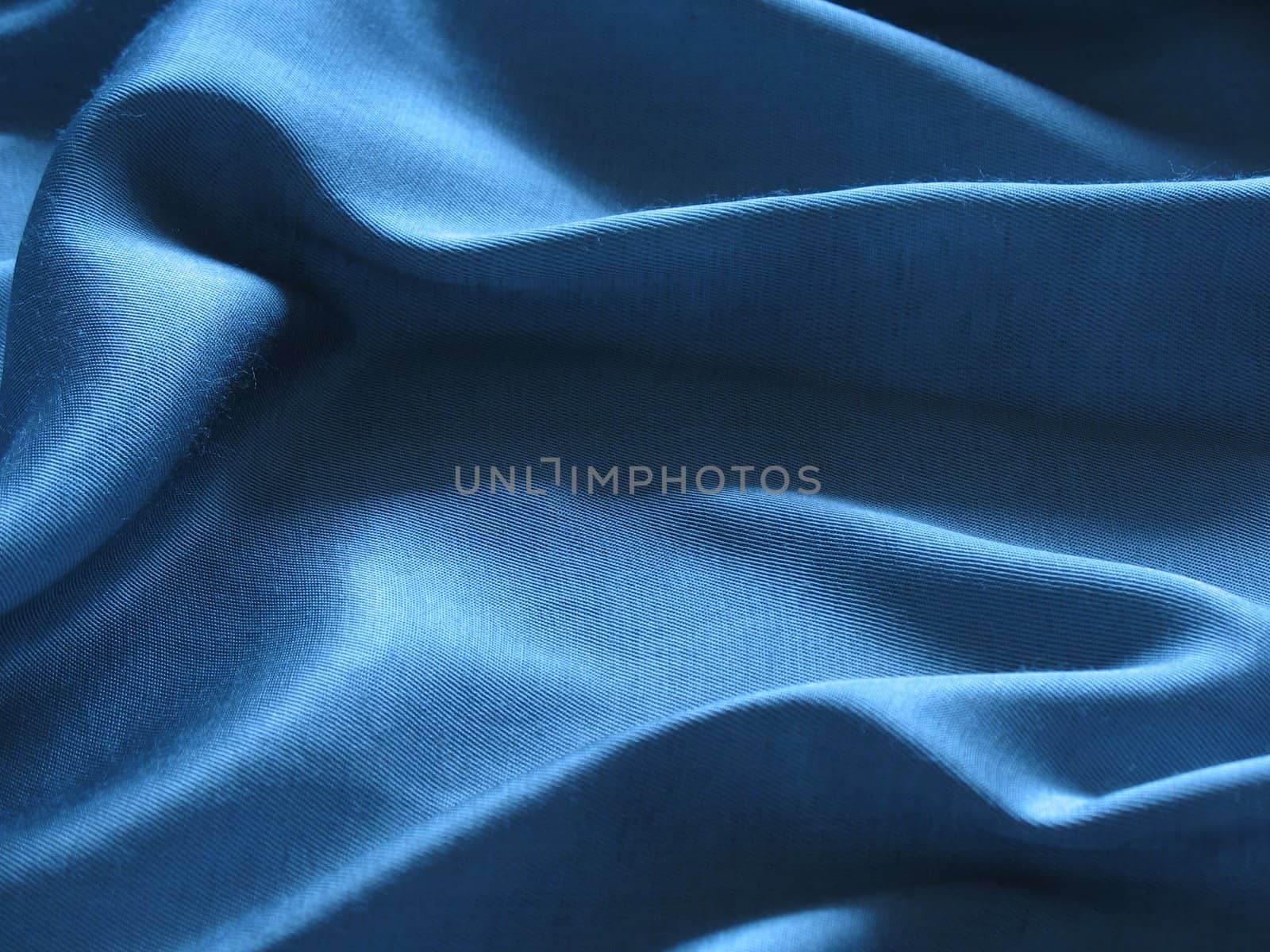 Abstract blue silk background, cloth is bedded by waves