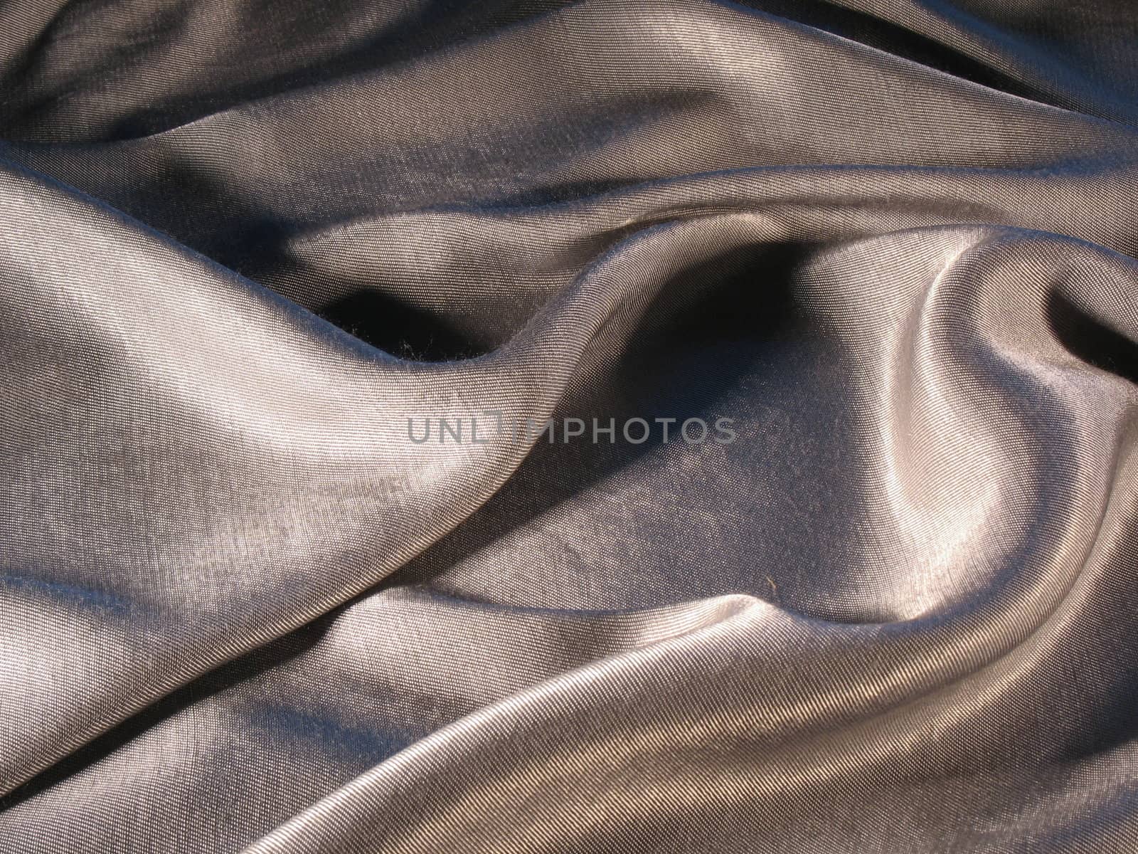Abstract grey silk background, cloth is bedded by waves