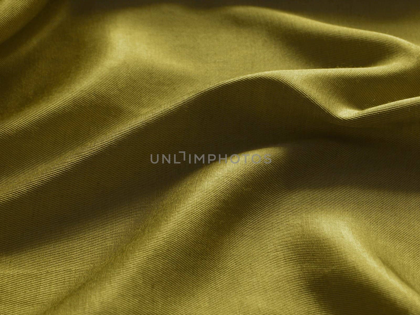 Abstract yellow silk background, cloth is bedded by waves